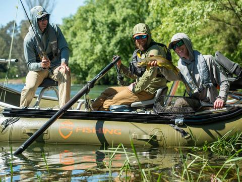 Fly fishing for trout on a drift boat on the Tumut river in the Snowy Mountains