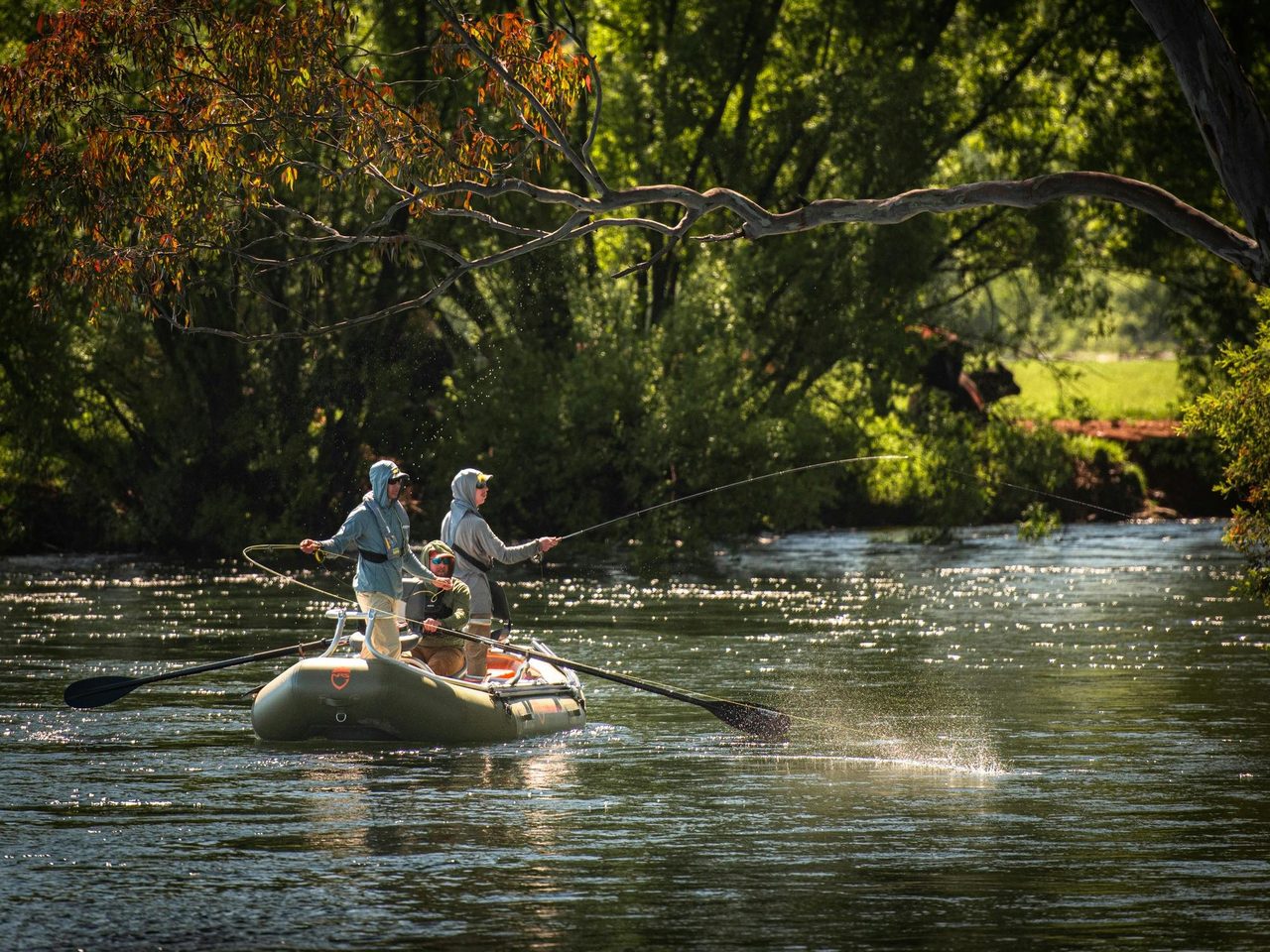 Drifting down the Tumut River fly fishing for trout.