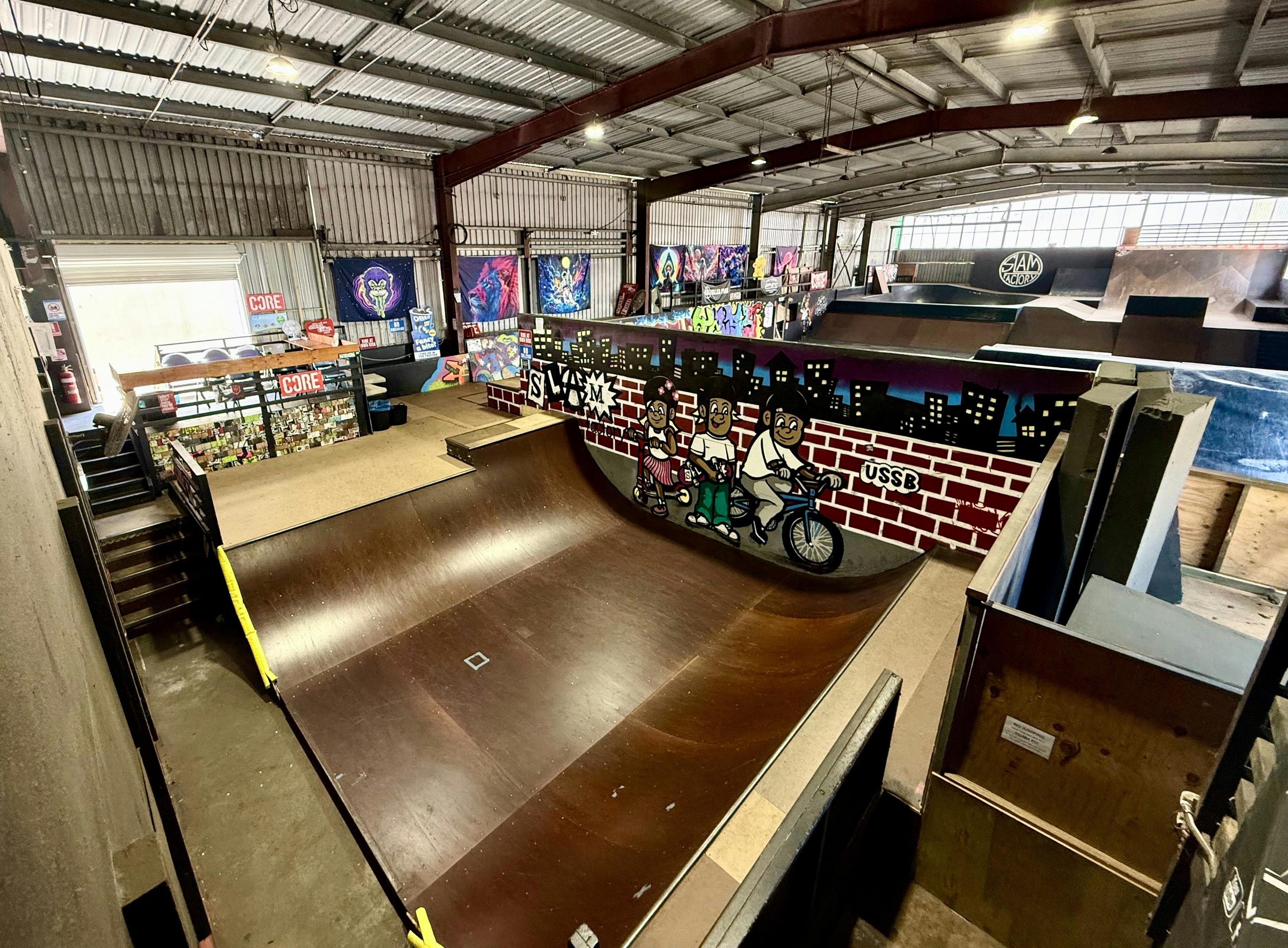 Slam Factory’s halfpipe and shop create a vibrant indoor ride space.