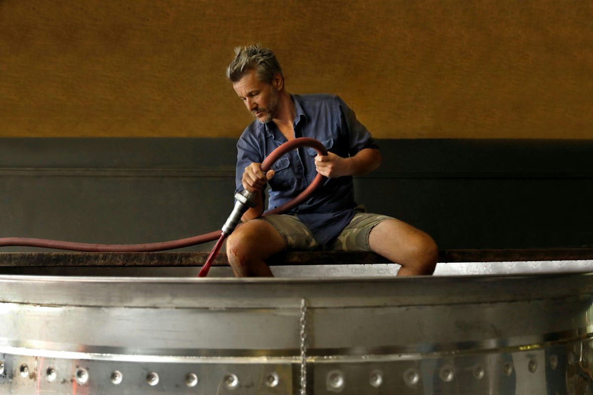 Winemaker Alex Woods pumping Shiraz juice in the winery.