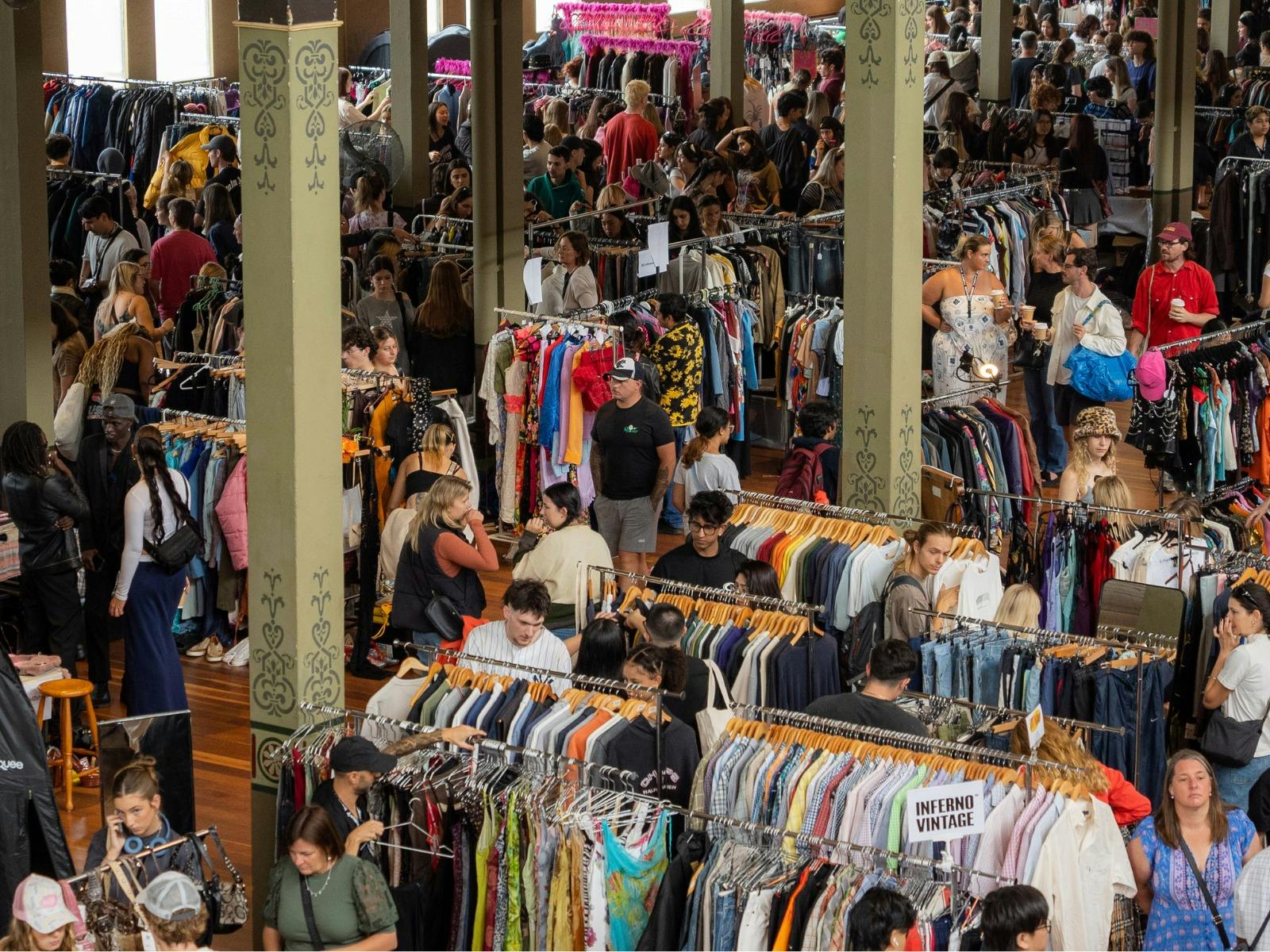 Pictured is a birds eye view of one of our markets, lots of people and clothing.