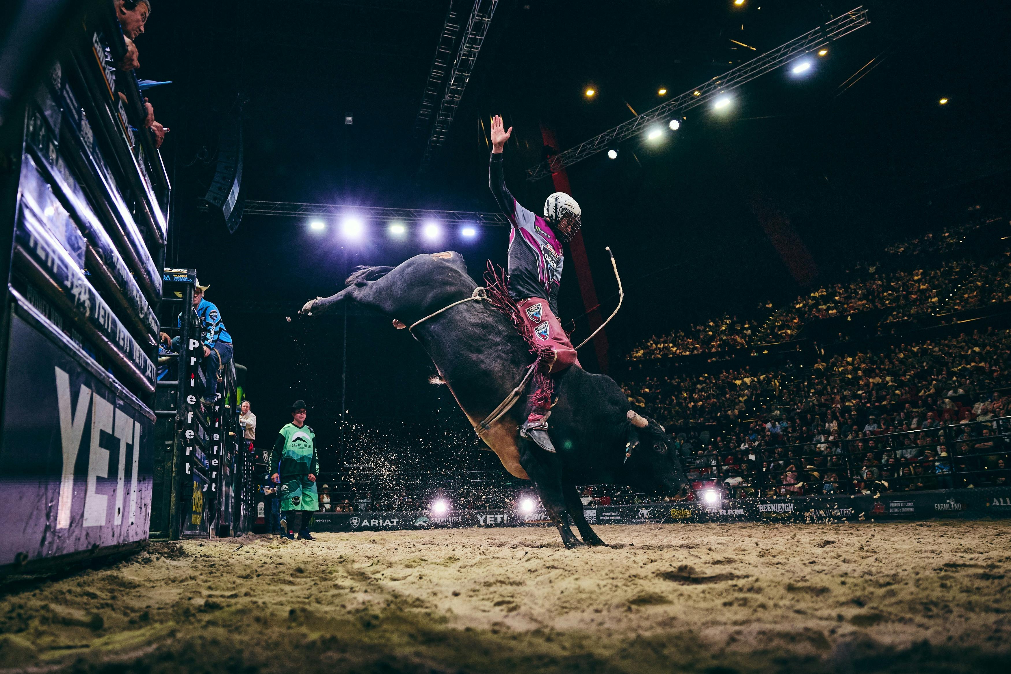 PBR athlete riding bull