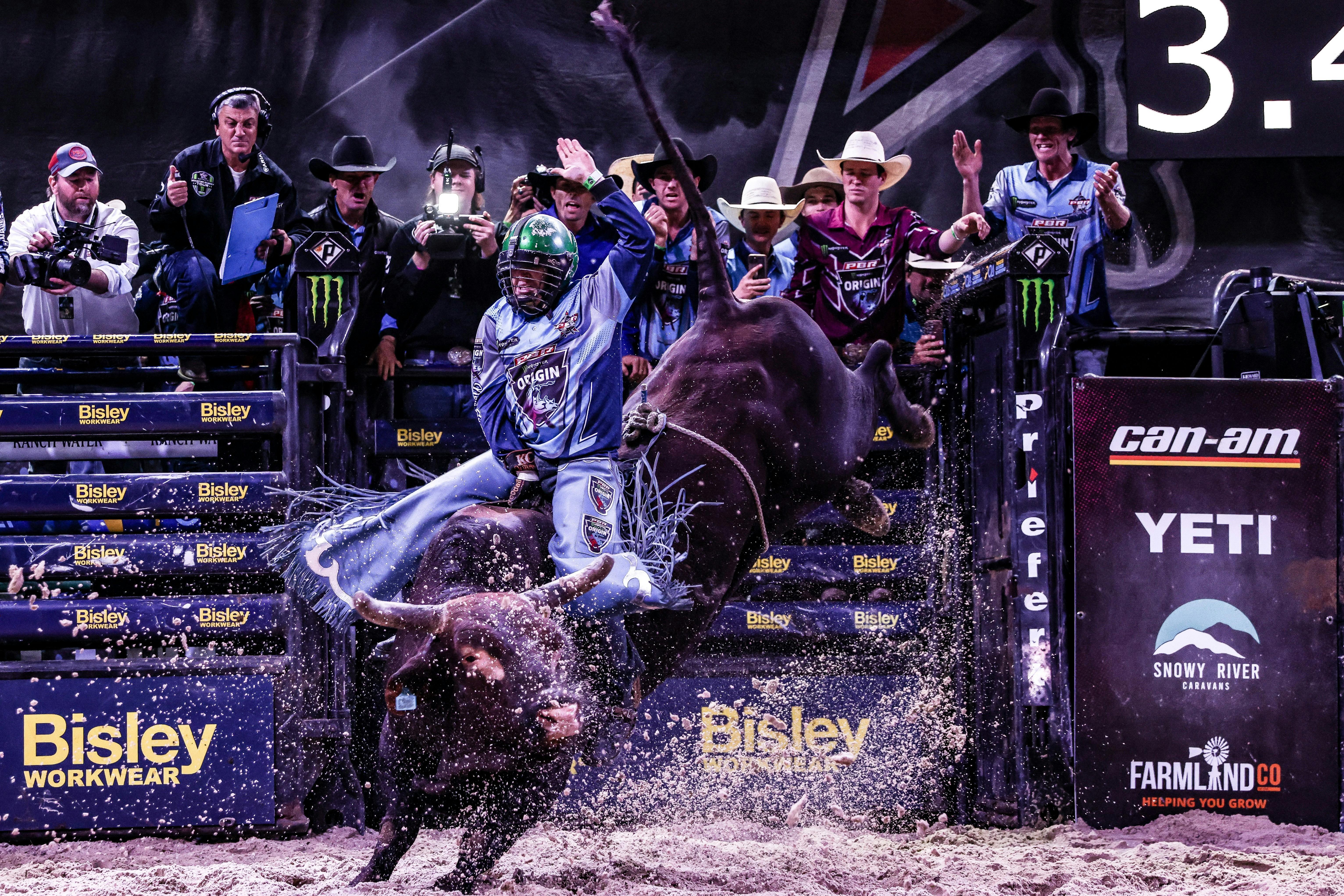 PBR athlete riding bull