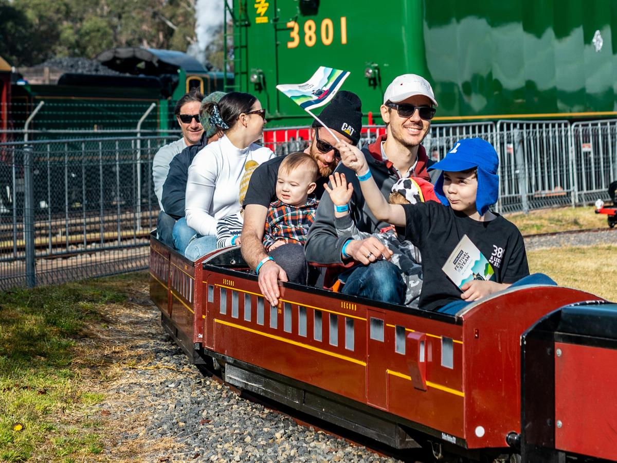 Family riding on mini train