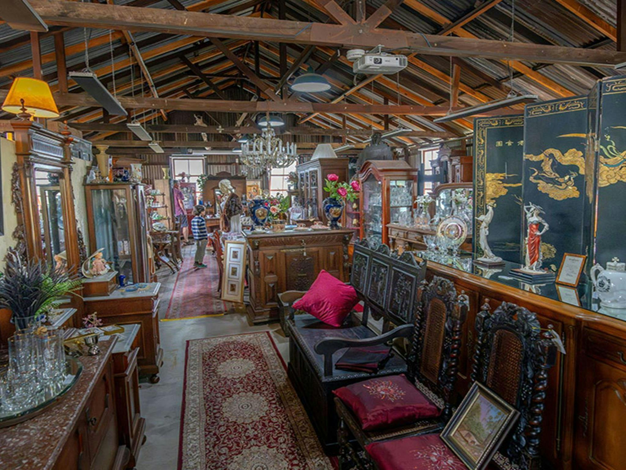 A large selection of antiques on display for sale inside the old Corneys Garage at Hartley Historic