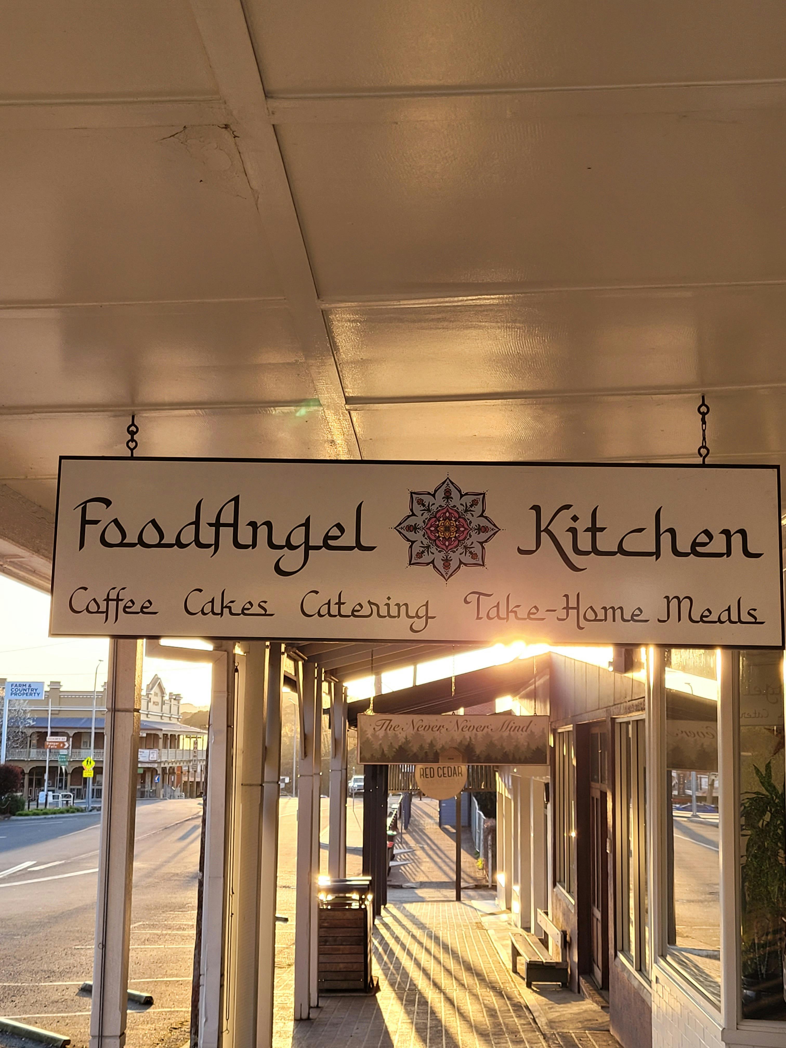 A sparkling summer sun shines through FoodAngel Kitchens awning sign.