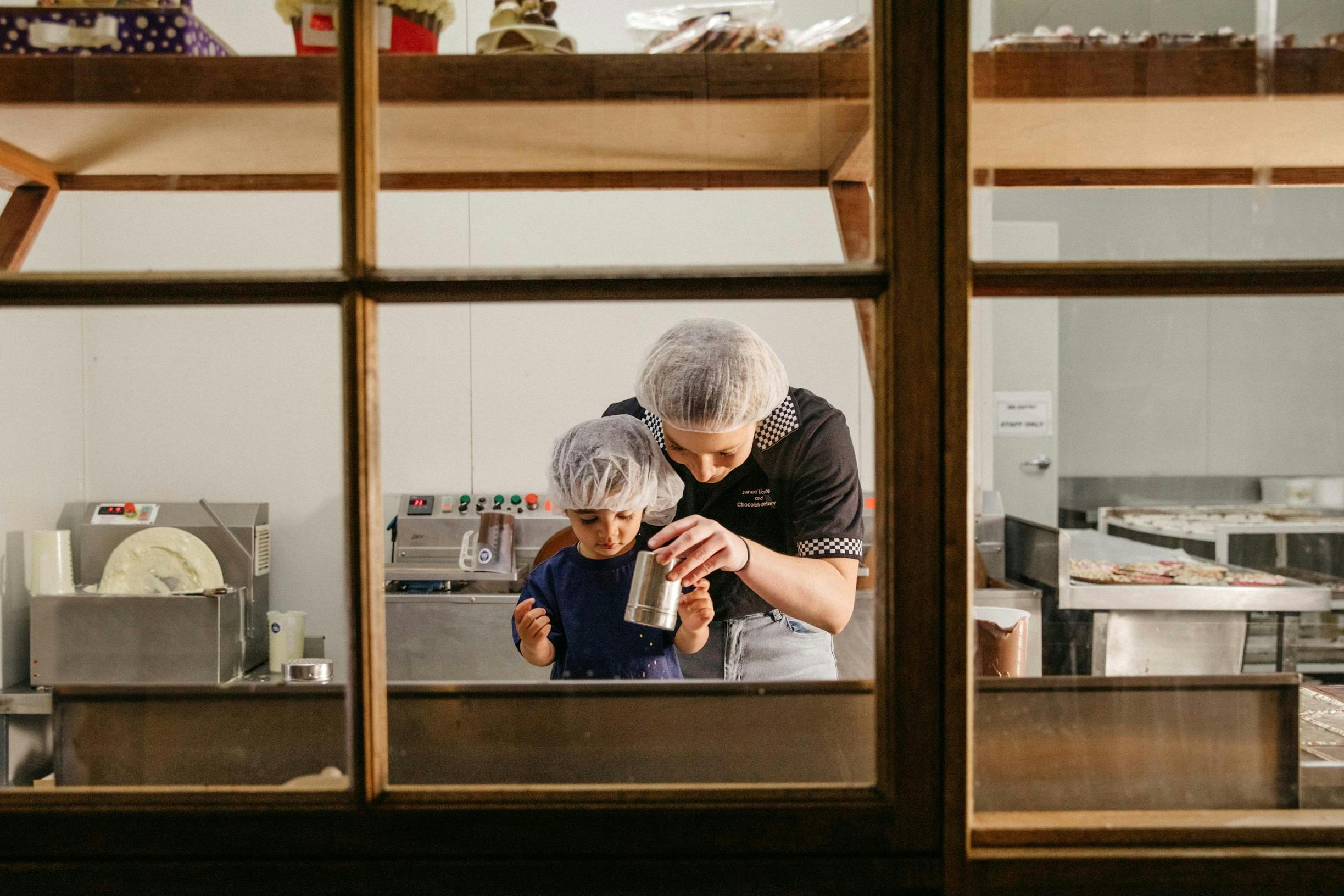 Young girl enjoying a giant chocolate freckle making lesson at Junee Licorice and Chocolate Factory