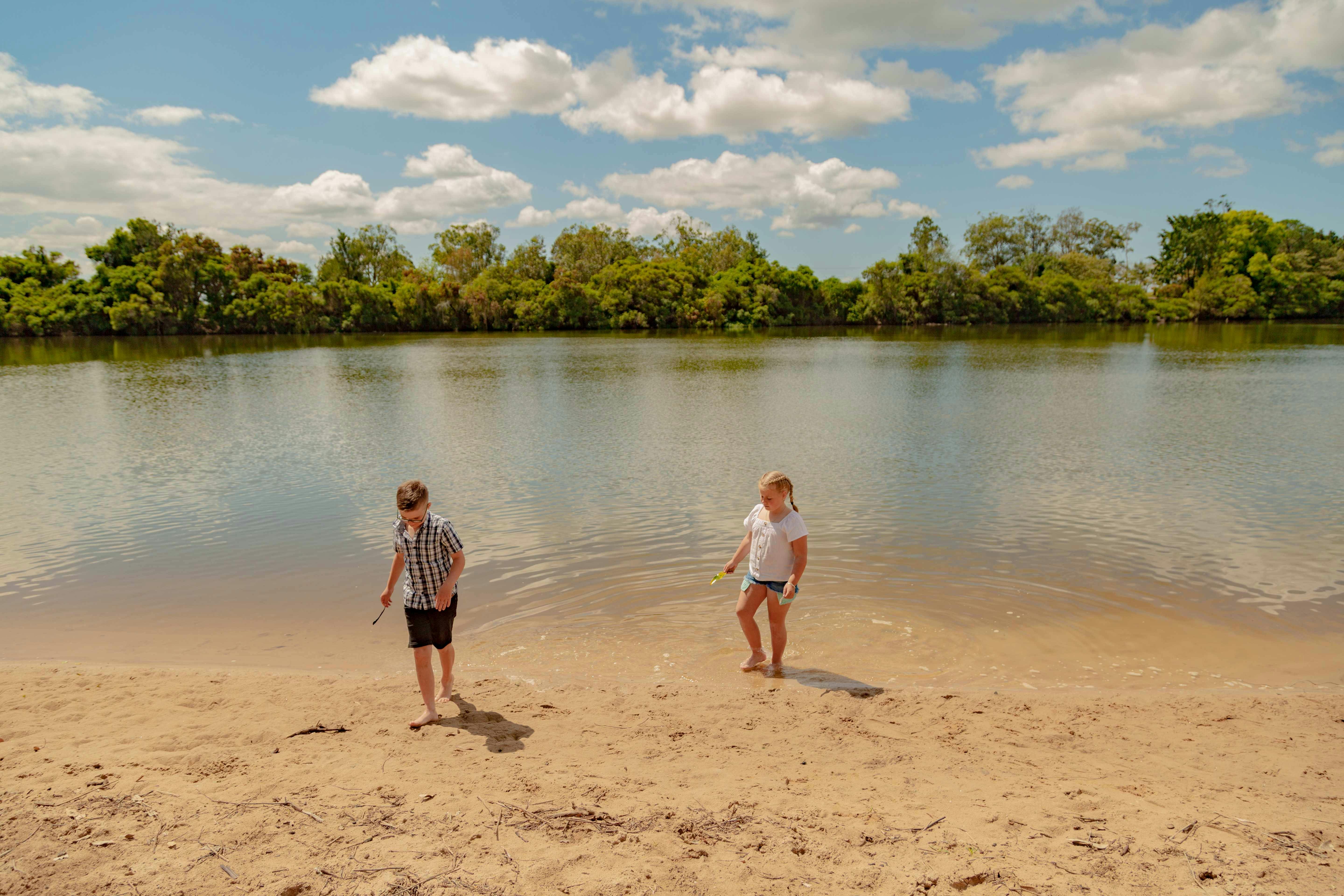 Two children playing on beach.