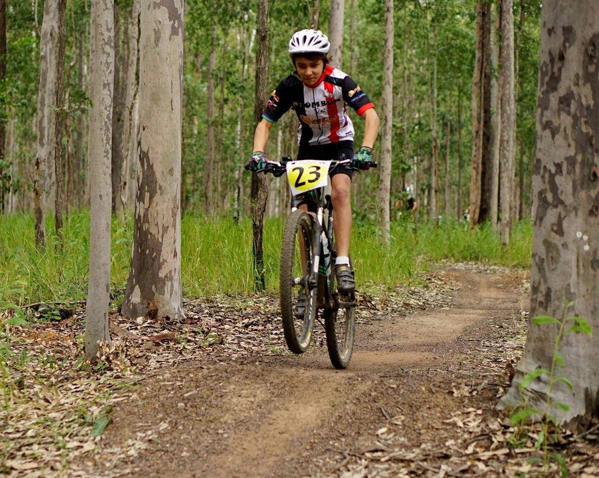 Person riding on bike on trail in forest