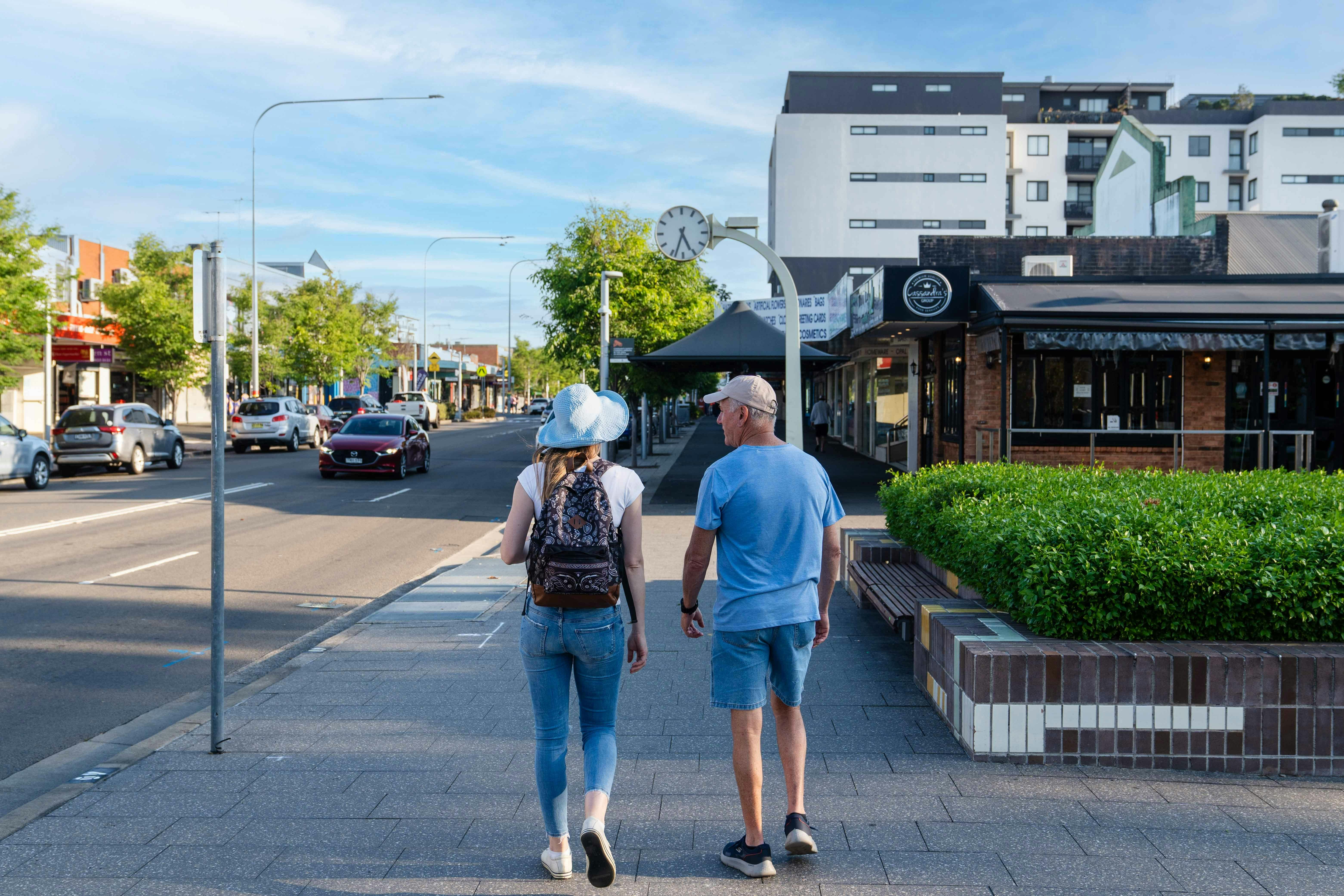 Man and woman walking in Coachmans Park St Marys