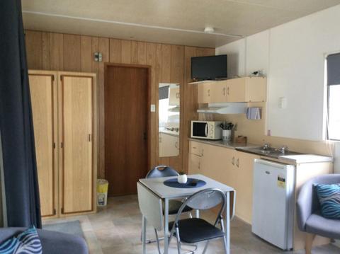 River Front for couples - living area with small two person table, and occasional chairs.