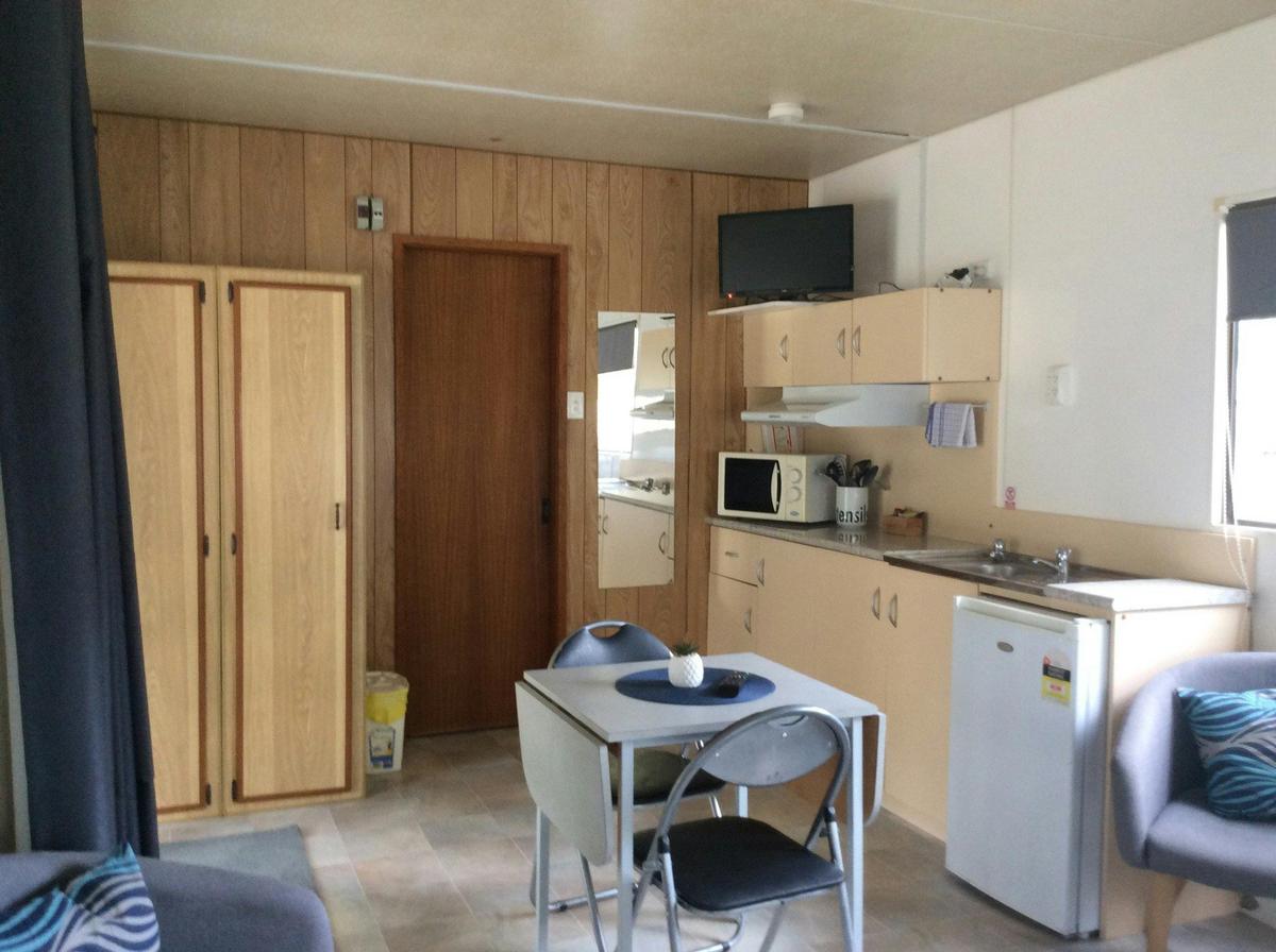 River Front for couples - living area with small two person table, and occasional chairs.