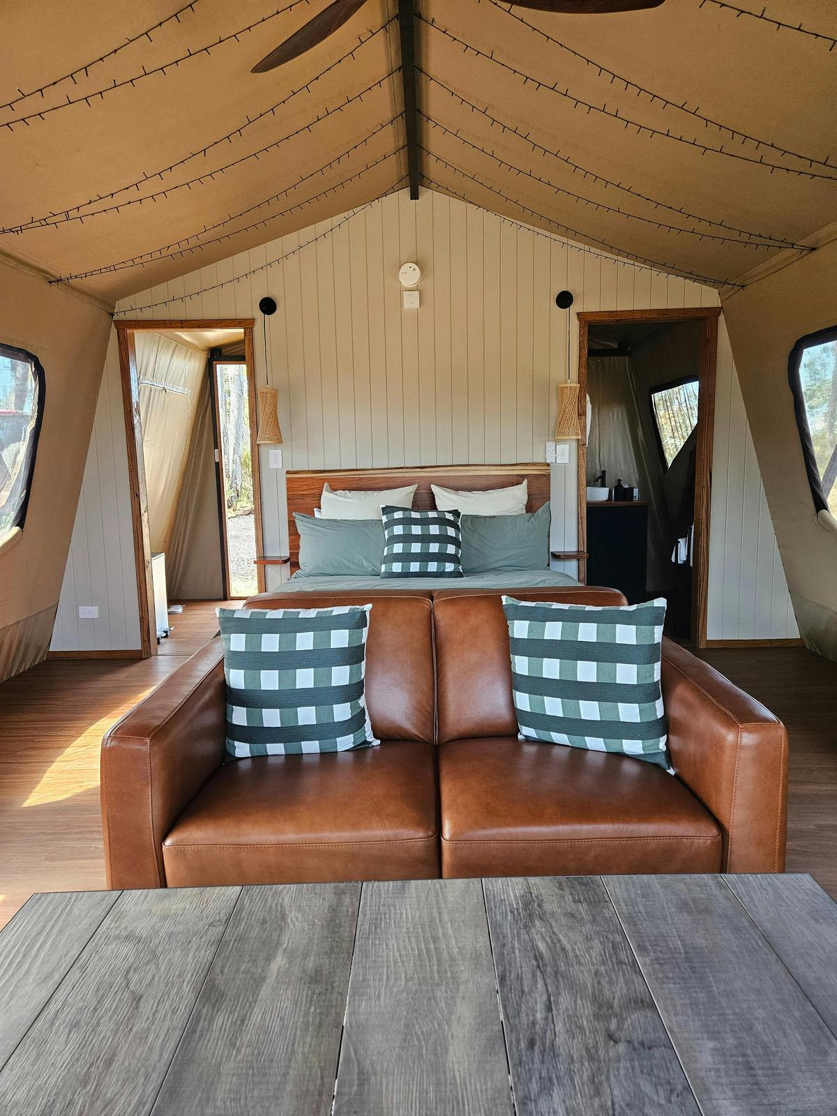 Main room in the tent showing sofa and bed.