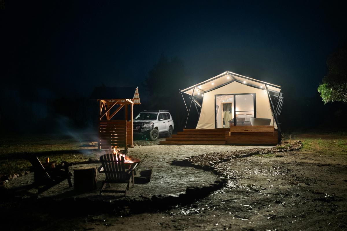 Long shot of tent from firepit at night