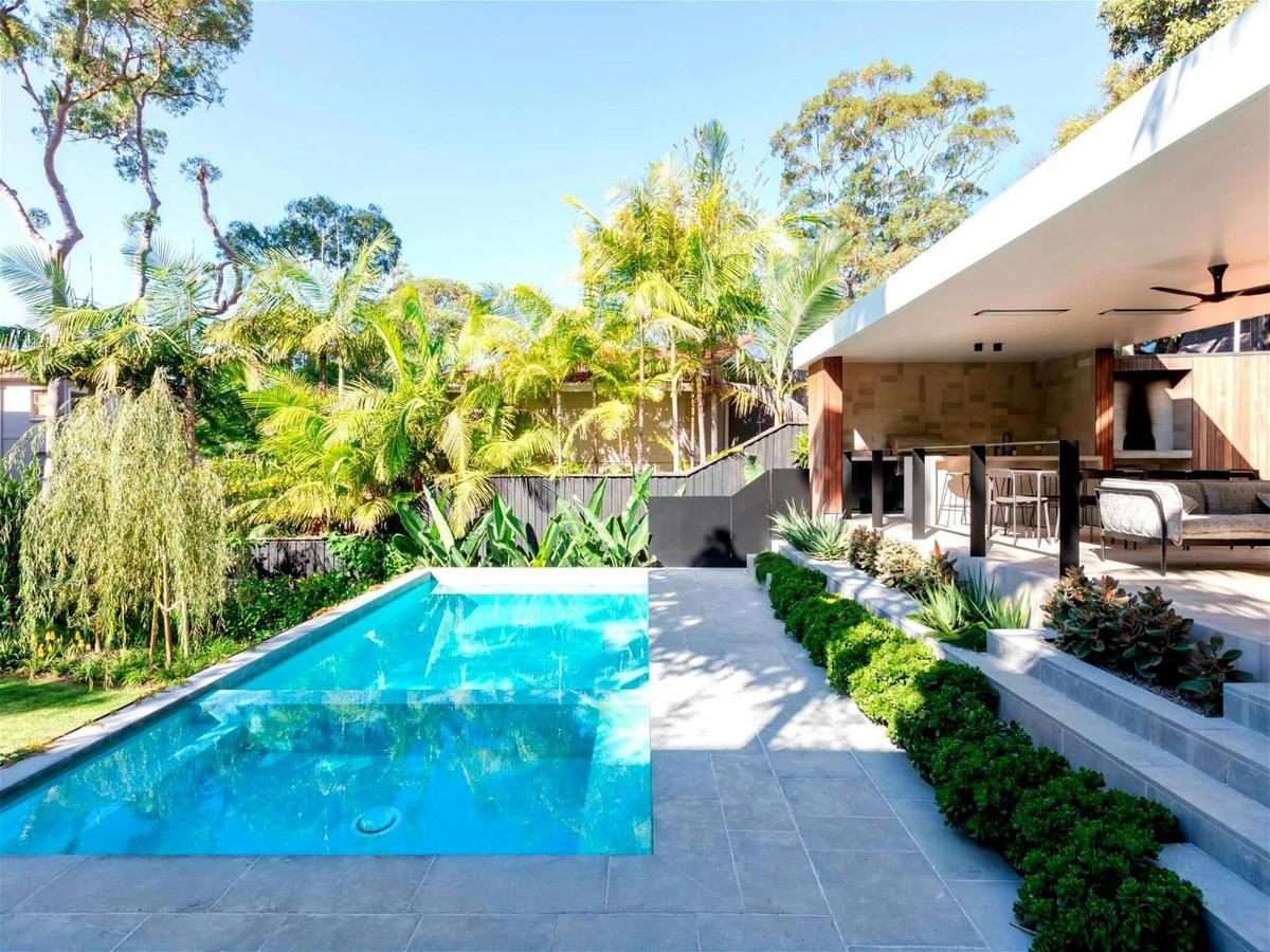 a view of the garden and pool, and a stunning island bench with seatin