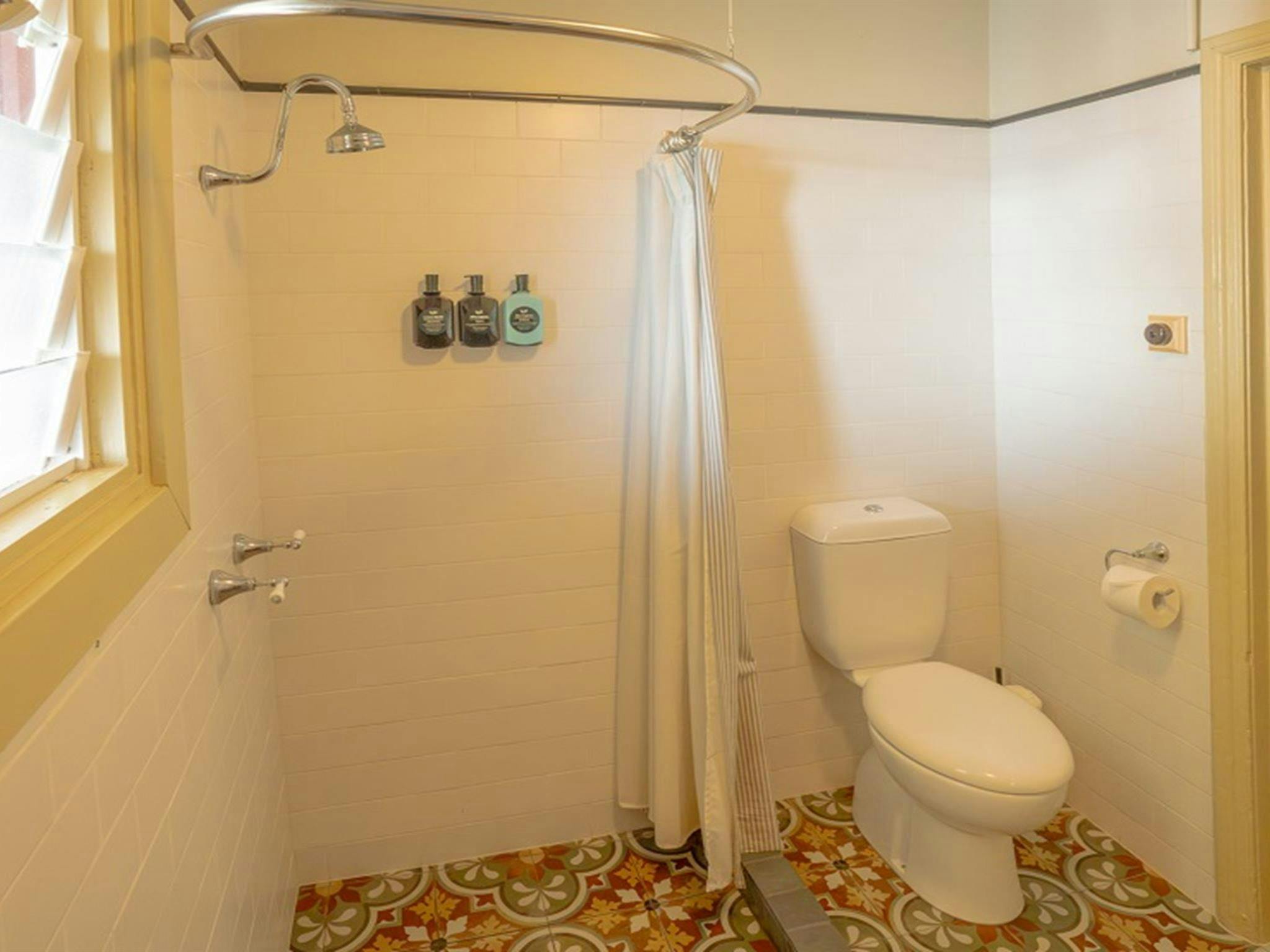 Bathroom, with step-in shower and toilet, Cape Byron Assistant Lighthouse Keepers Cottages. Credit: