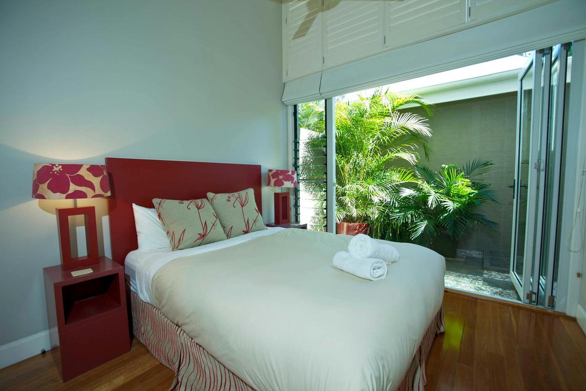 The queen bedroom has a soaring ceiling and a private courtyard with a hot & cold shower