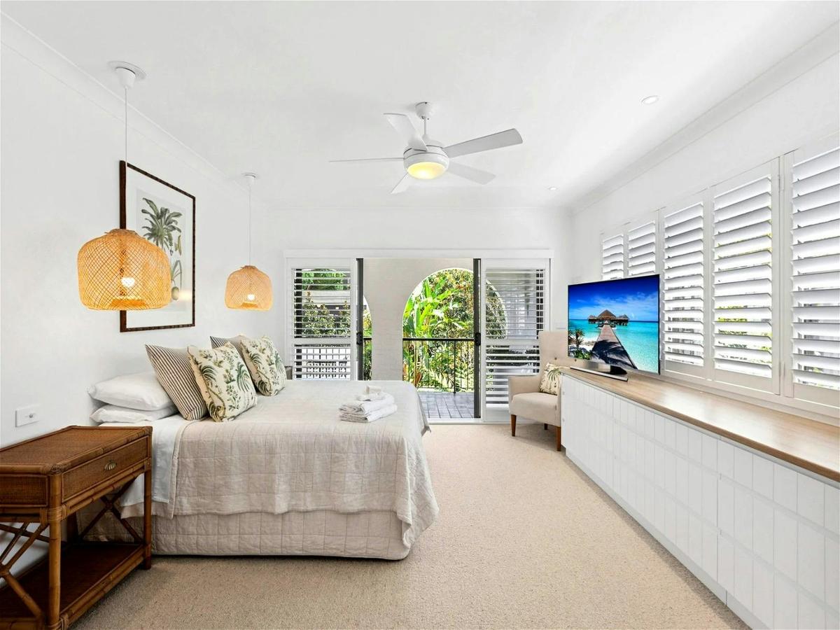 Master bedroom with ample space, featuring a hotel-style walk-in robe leading to the ensuite