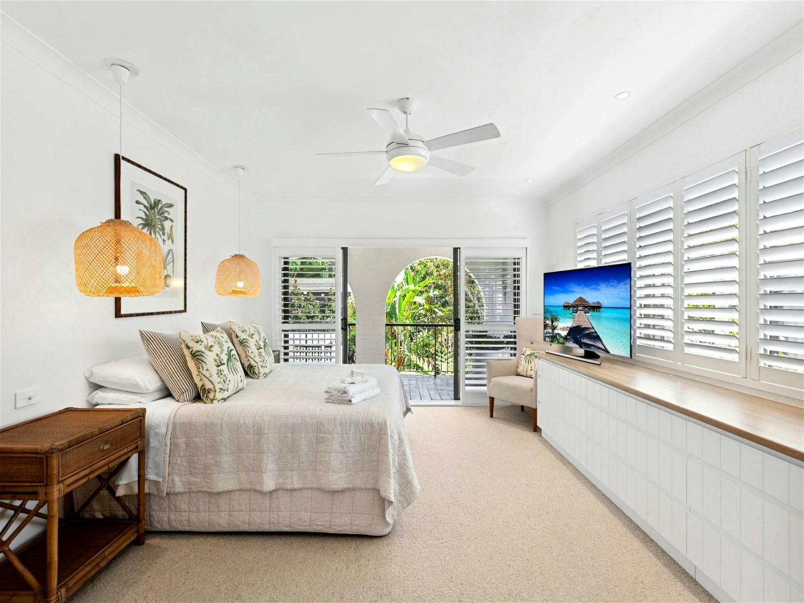Master bedroom with ample space, featuring a hotel-style walk-in robe leading to the ensuite