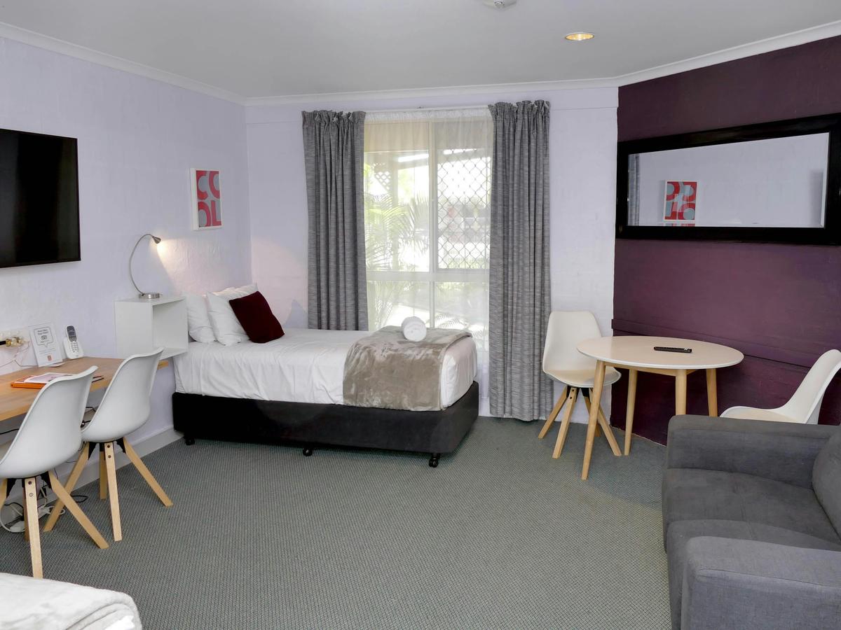 Premium Family room with two single beds table, desk and sofa. Adjoining Queen bedroom with spa