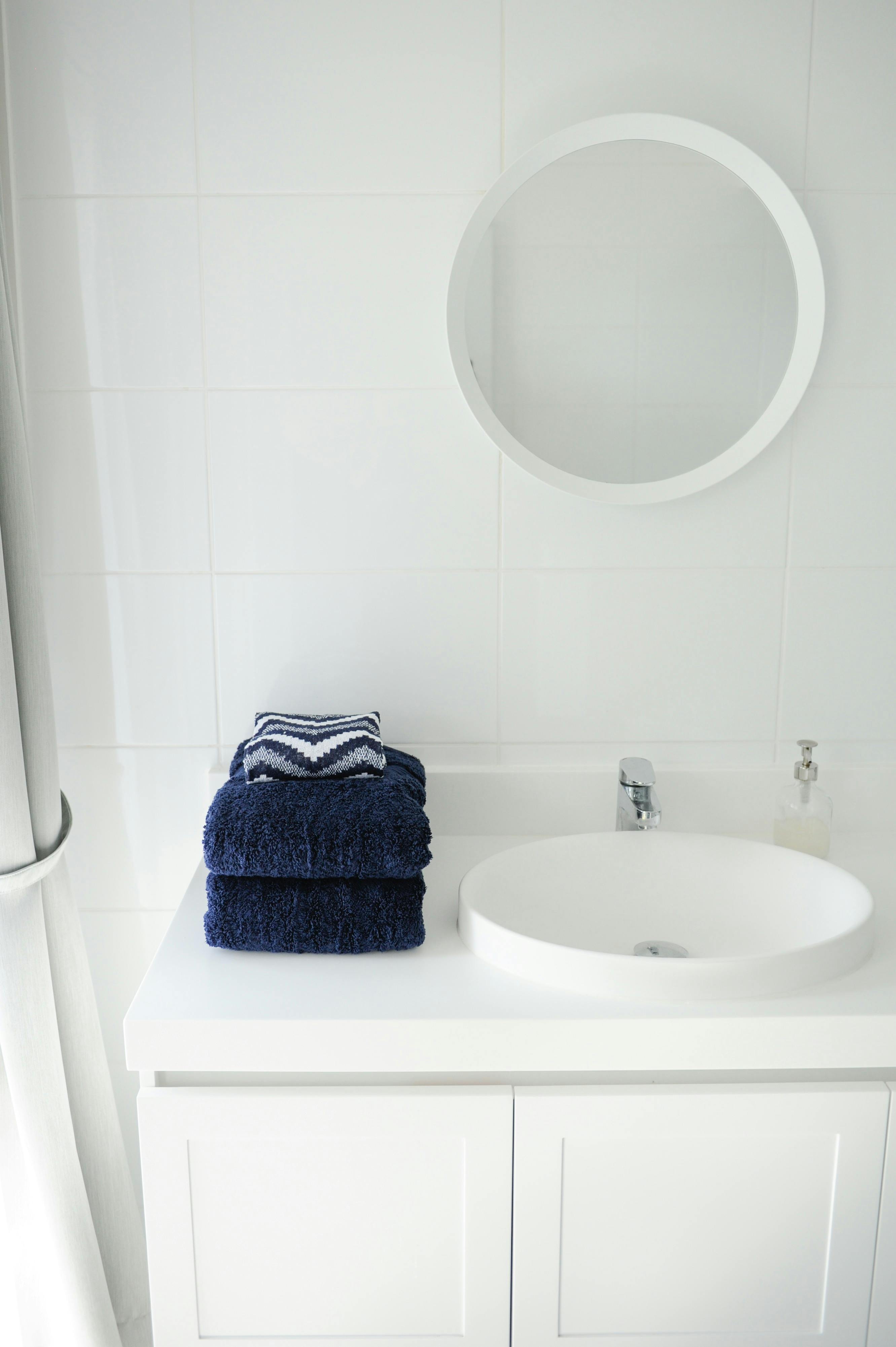 Main bathroom with shower over deep bath tub and washer/dryer.