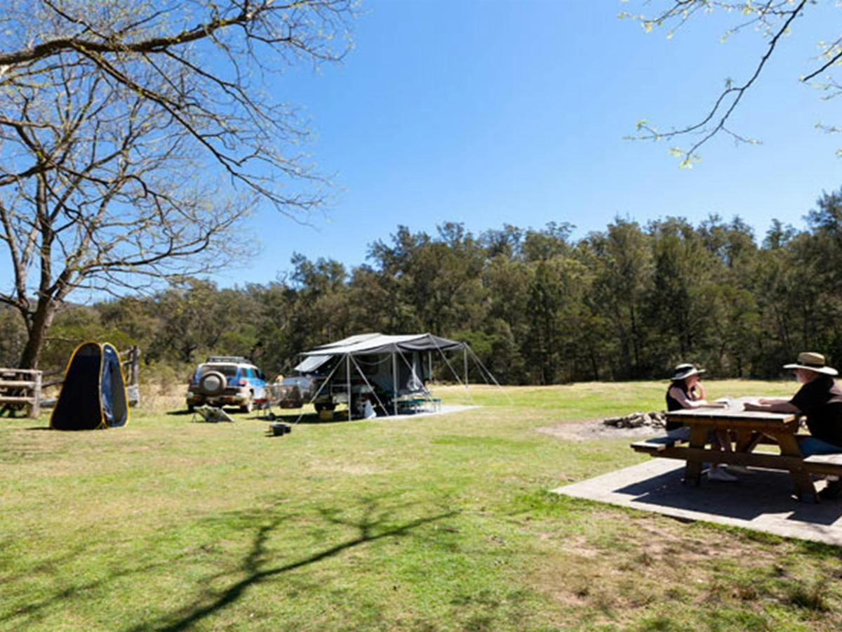 A couple having lunch on a park bench, Bendethera Valley campground, Deua National Park. Photo: