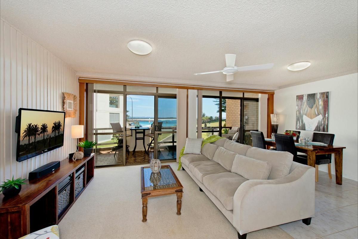 Lounge and dining area with beach views