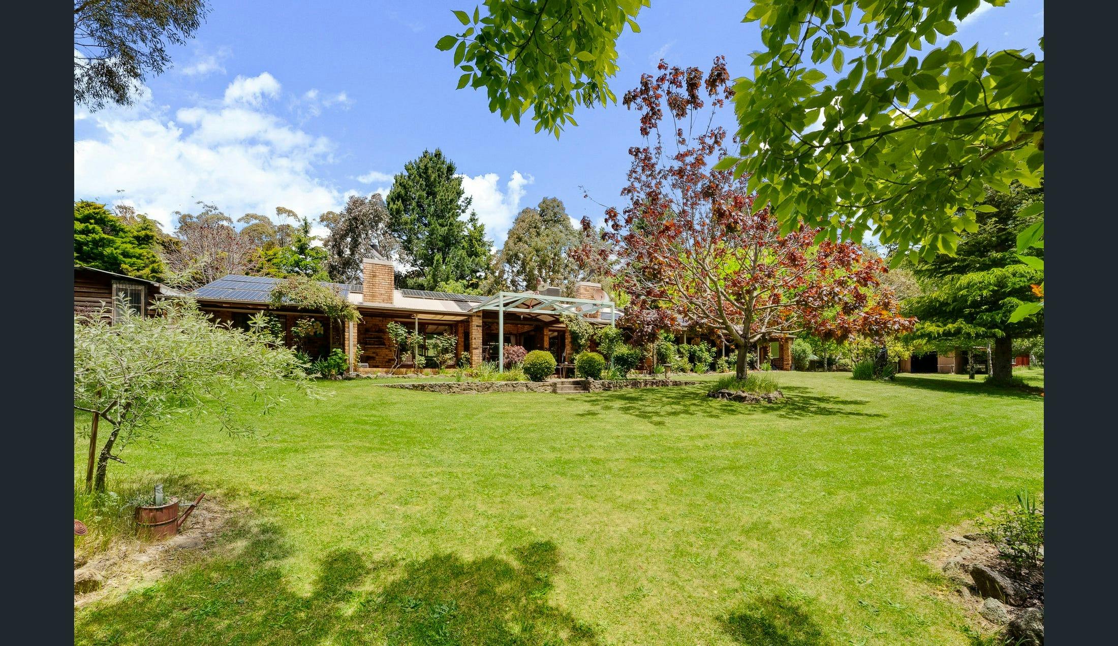 Big Yard Farm features vernadahs, rolling green lawsn and established gardens