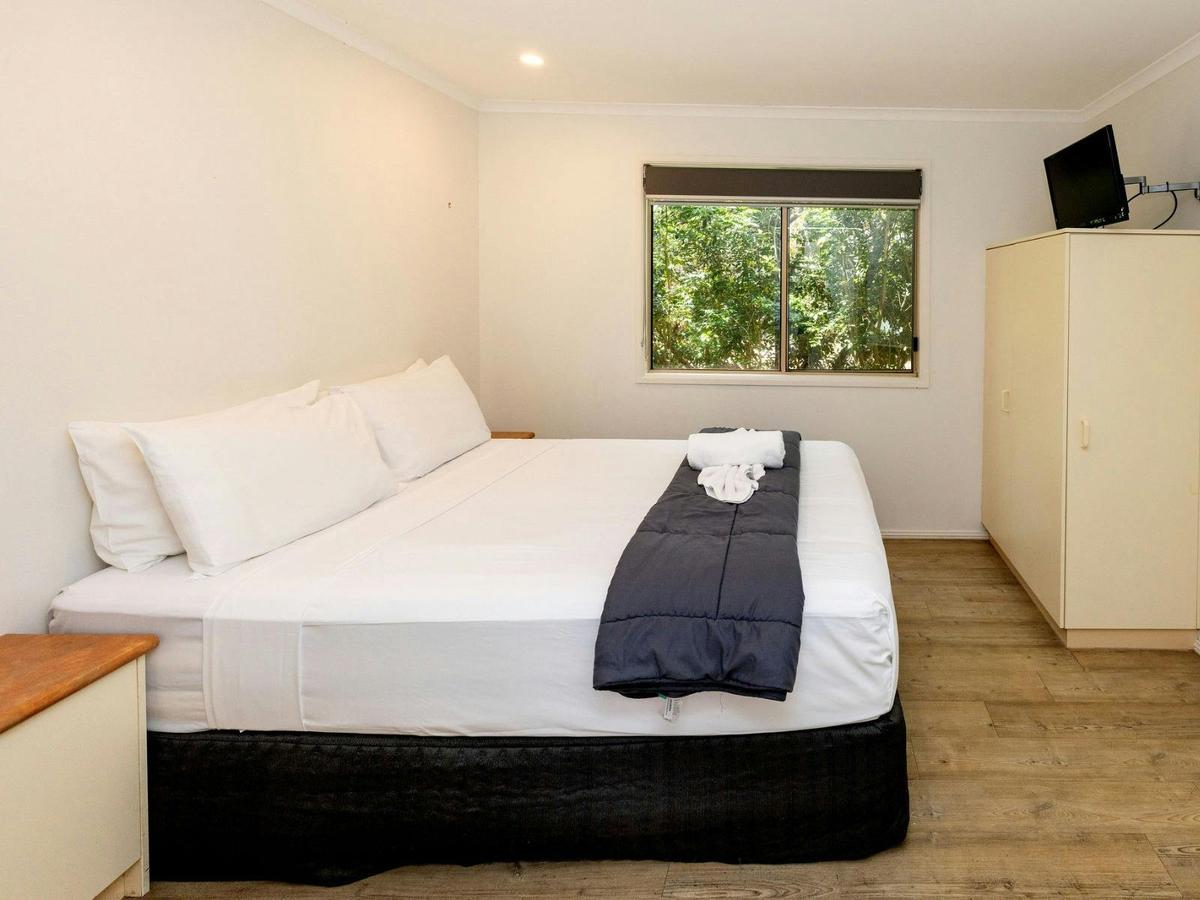 Master bedroom with queen bed and window