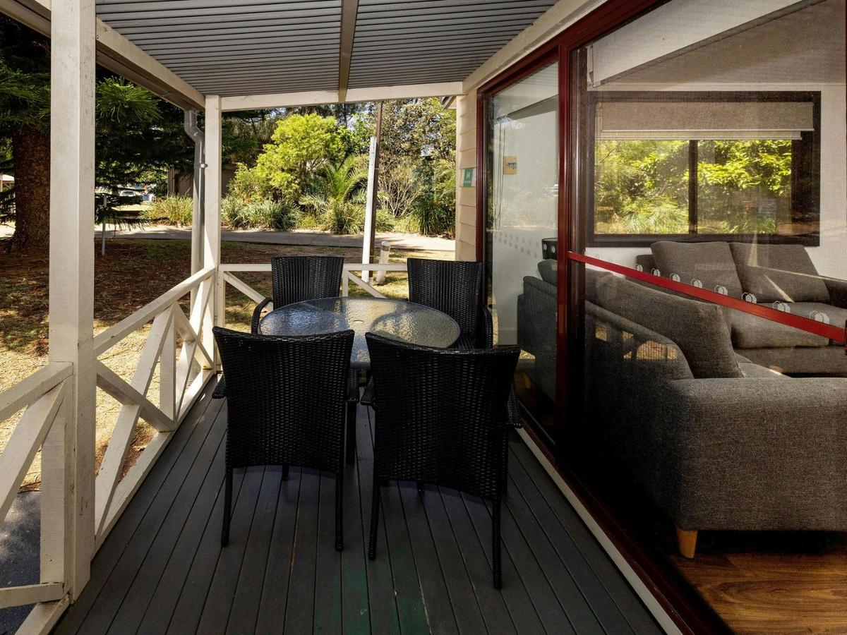 Front of cabin with deck and outdoor dining setting