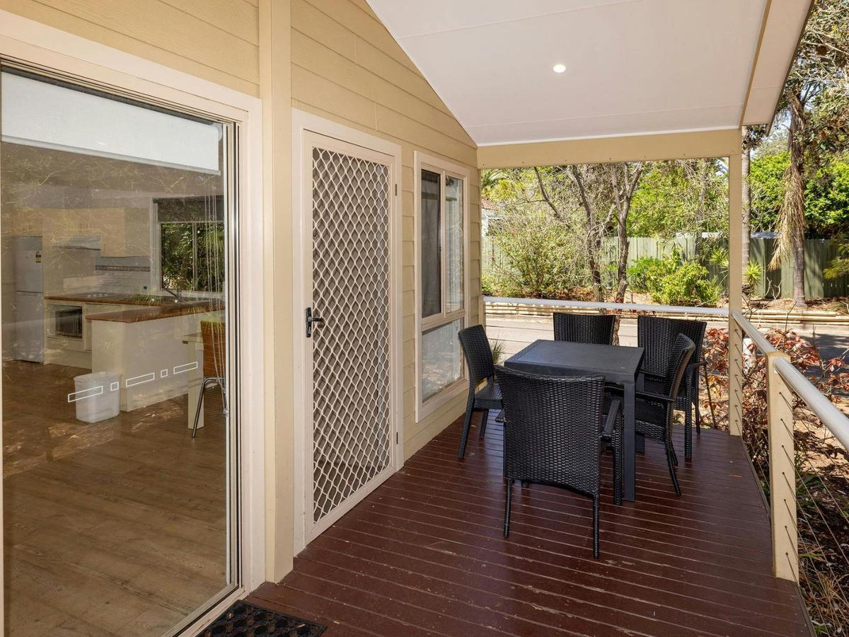 Front of cabin with deck and outdoor dining setting