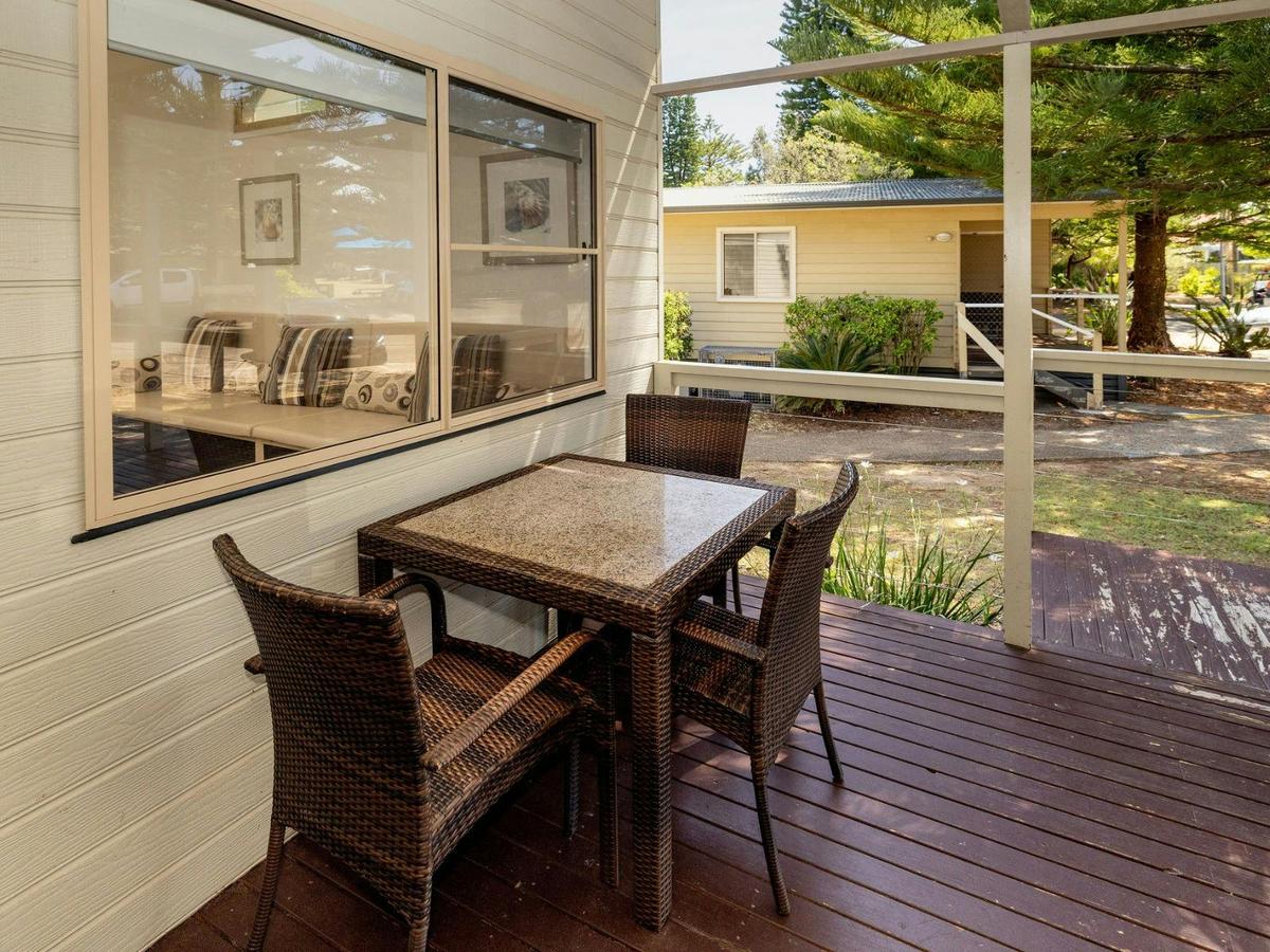 Front of cabin with deck and outdoor dining setting