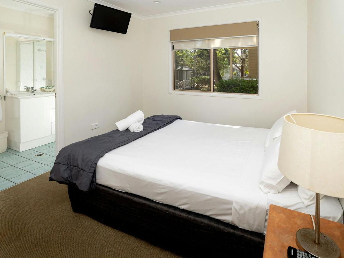 Double bed, with window and door visible to ensuite