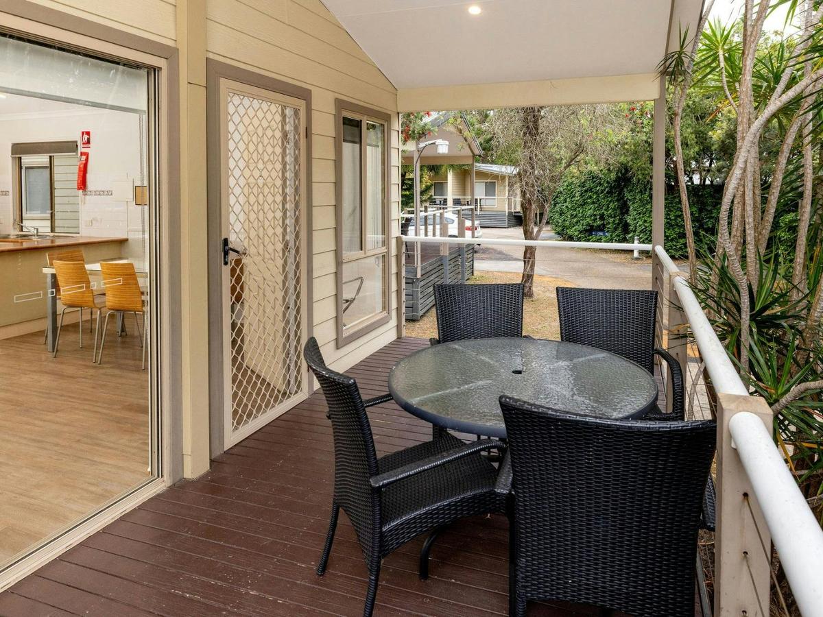 Front of cabin with deck and outdoor dining setting