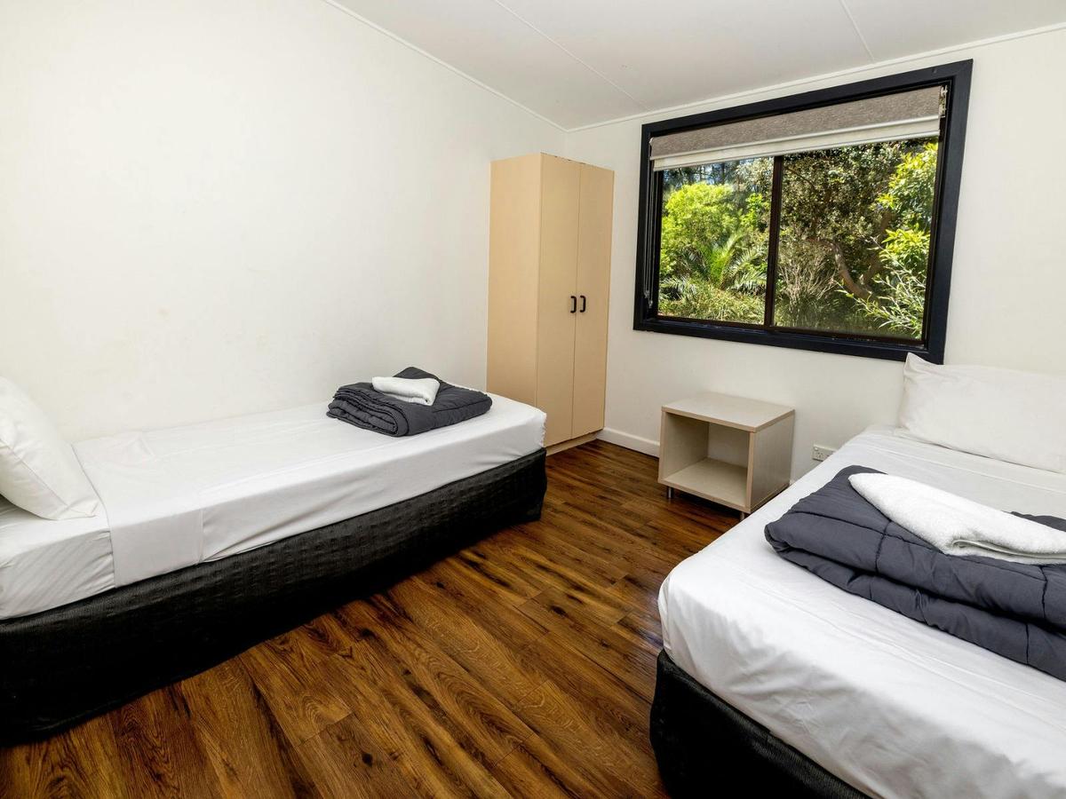 2nd bedroom with two single beds and a wardrobe