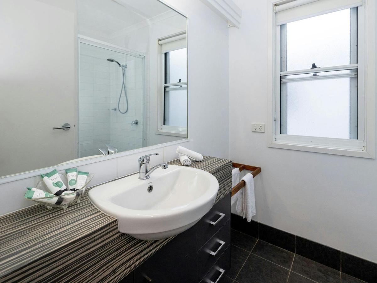 Bathroom with vanity, mirror and toilet