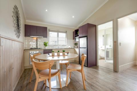 Superior Cabin (2BR) Kitchen & Dining Room | Tasman Holiday Parks - Ballina
