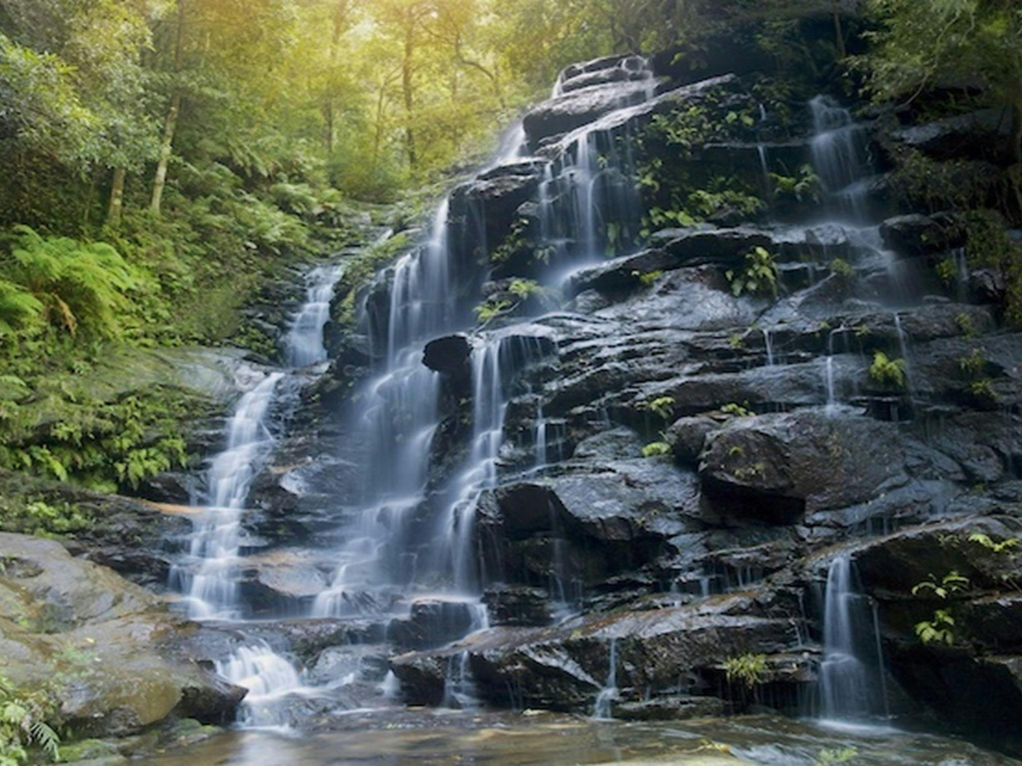 Water cascades over rock ledges at Empress Falls at the end of Empress Canyon in Blue Mountains