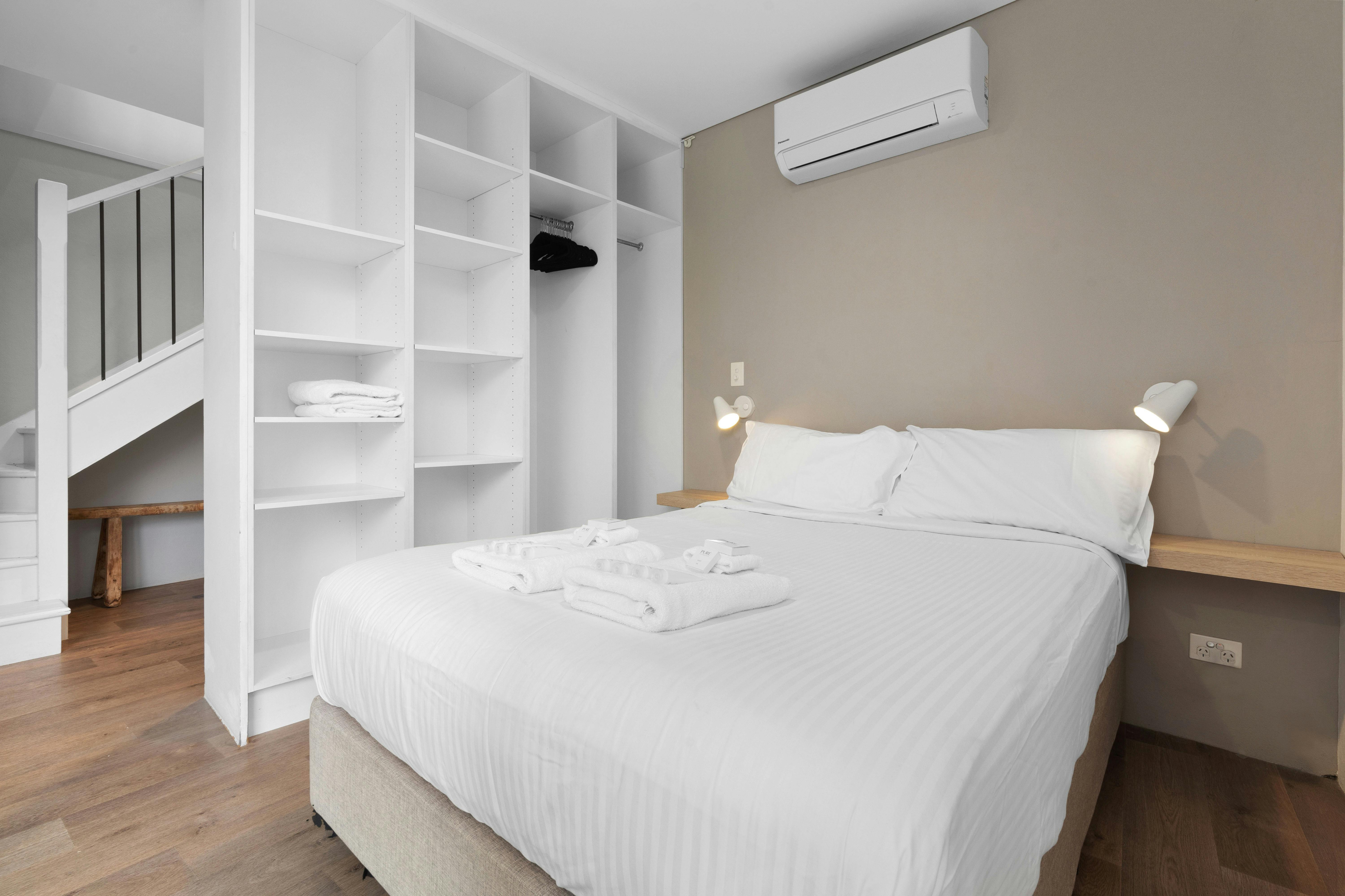 Stunning city views from a modern apartment with a cozy living space and balcony seating.