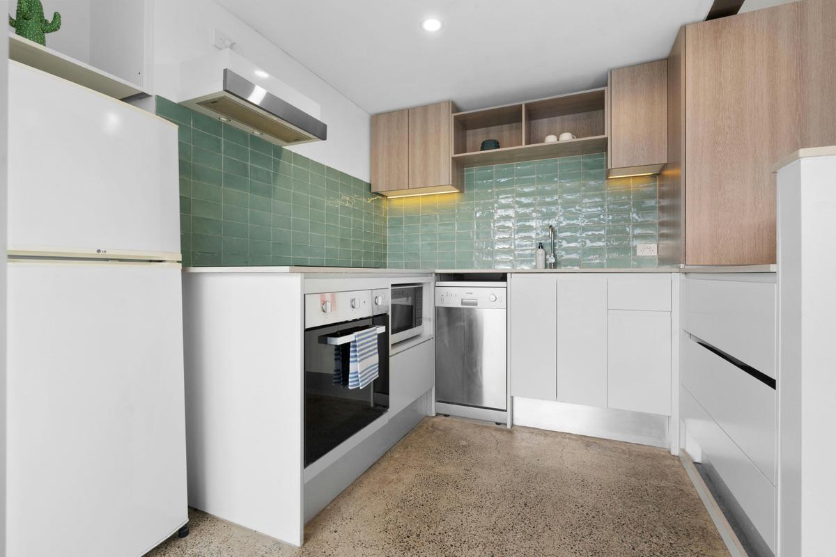 Stunning city views from a modern apartment with a cozy living space and balcony seating.