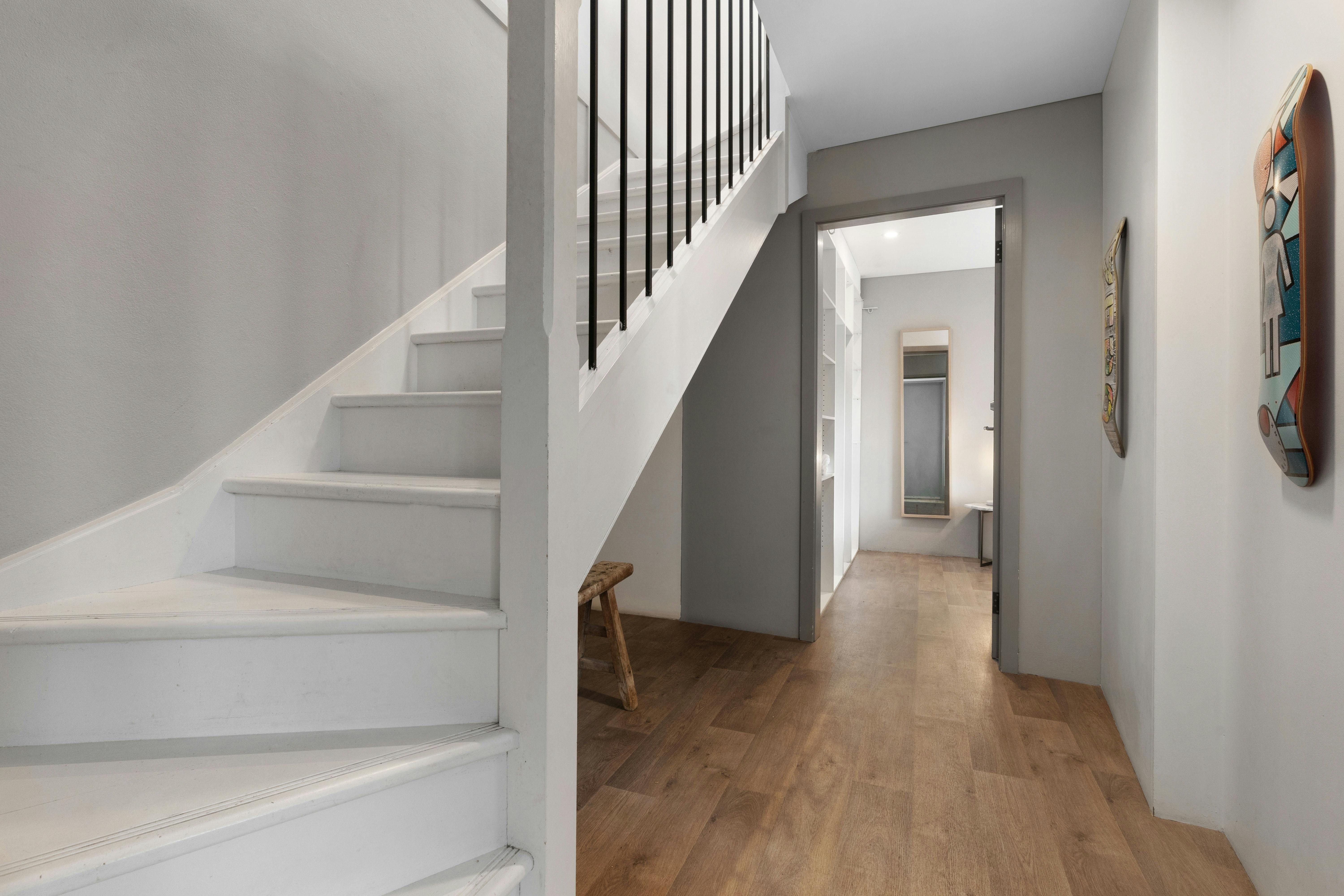 Stunning city views from a modern apartment with a cozy living space and balcony seating.