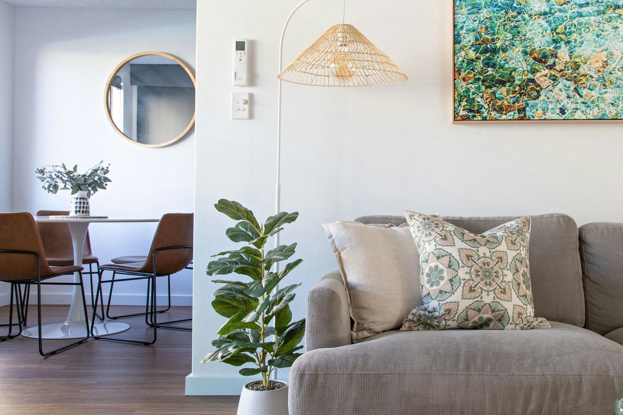 The sunlit lounge area opens to the dining area with views out to the pool.