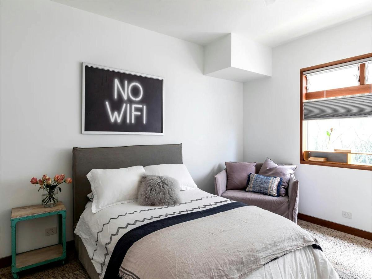Modern minimalist bedroom with sleek furniture and neutral color palette