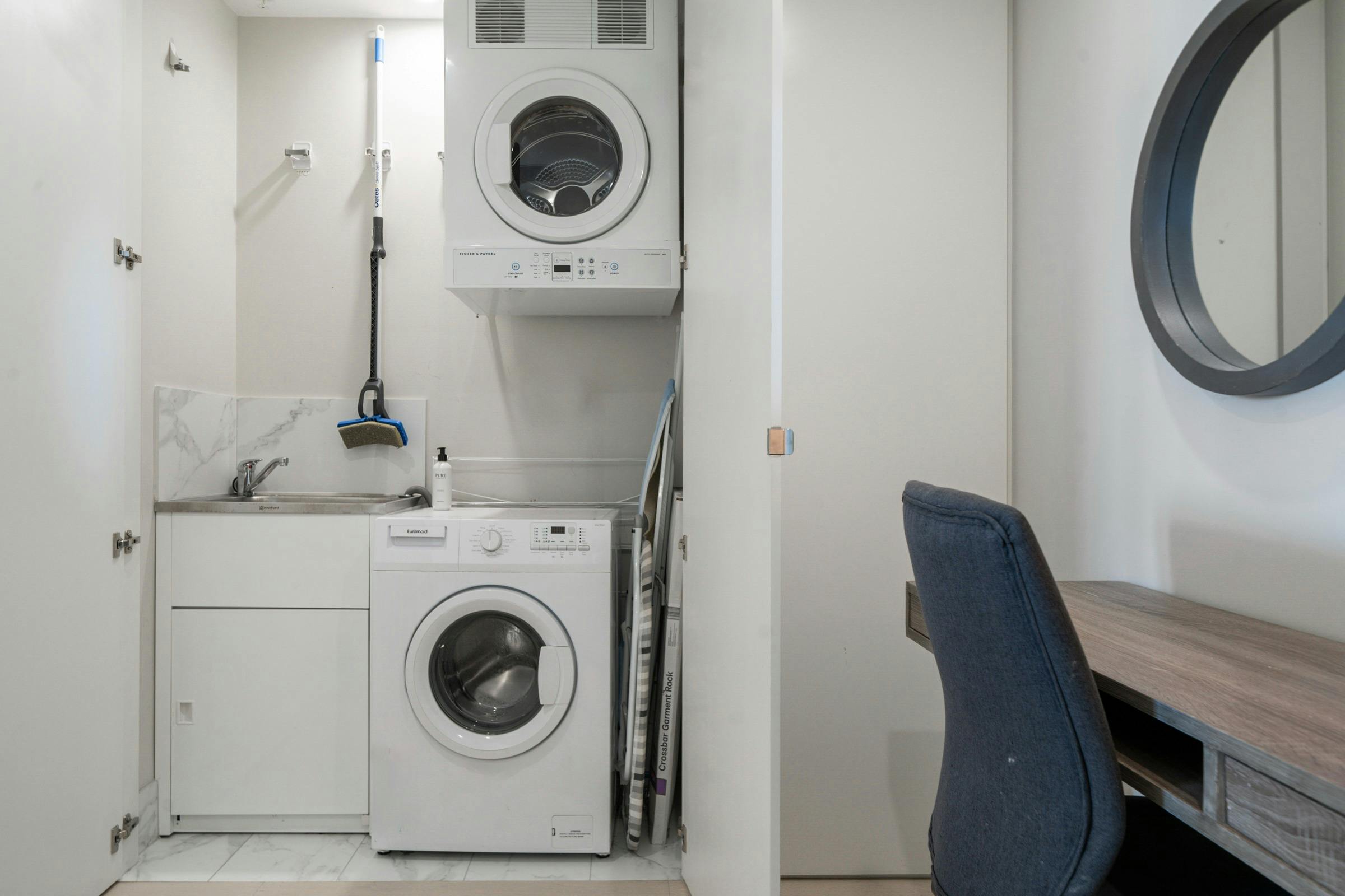 Convenient laundry area with washer, dryer, and workspace.