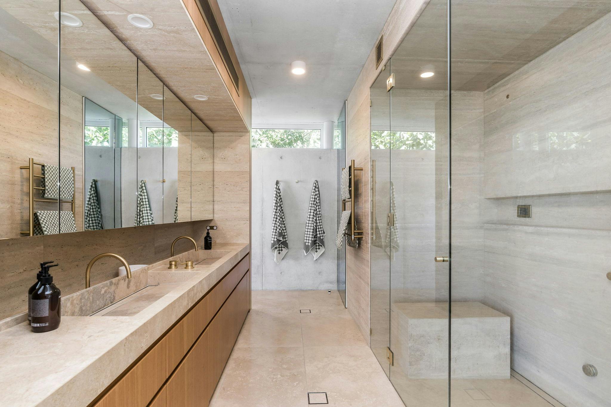 Modern bathroom with a walk-in shower, freestanding tub, and sleek, minimalist design