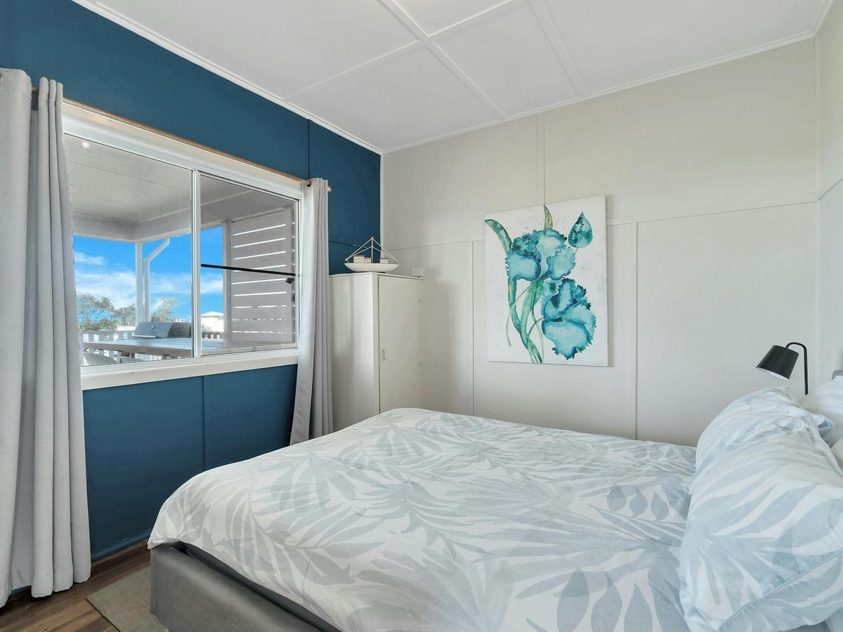 A cozy, beach-style master bedroom with ocean views.