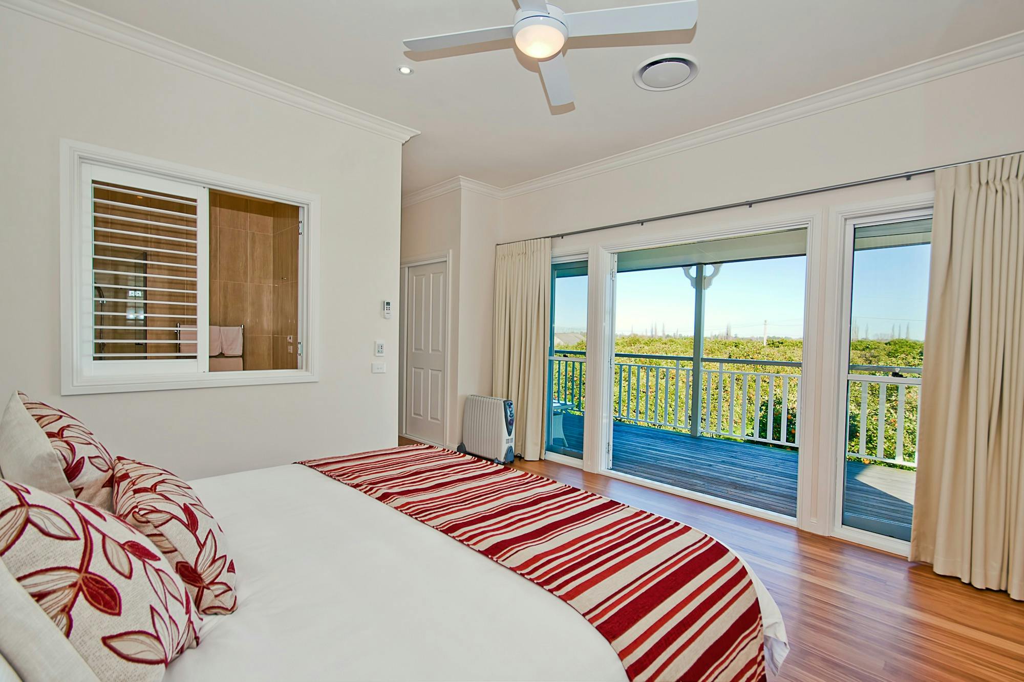 Main orchard view bedroom with verandah access