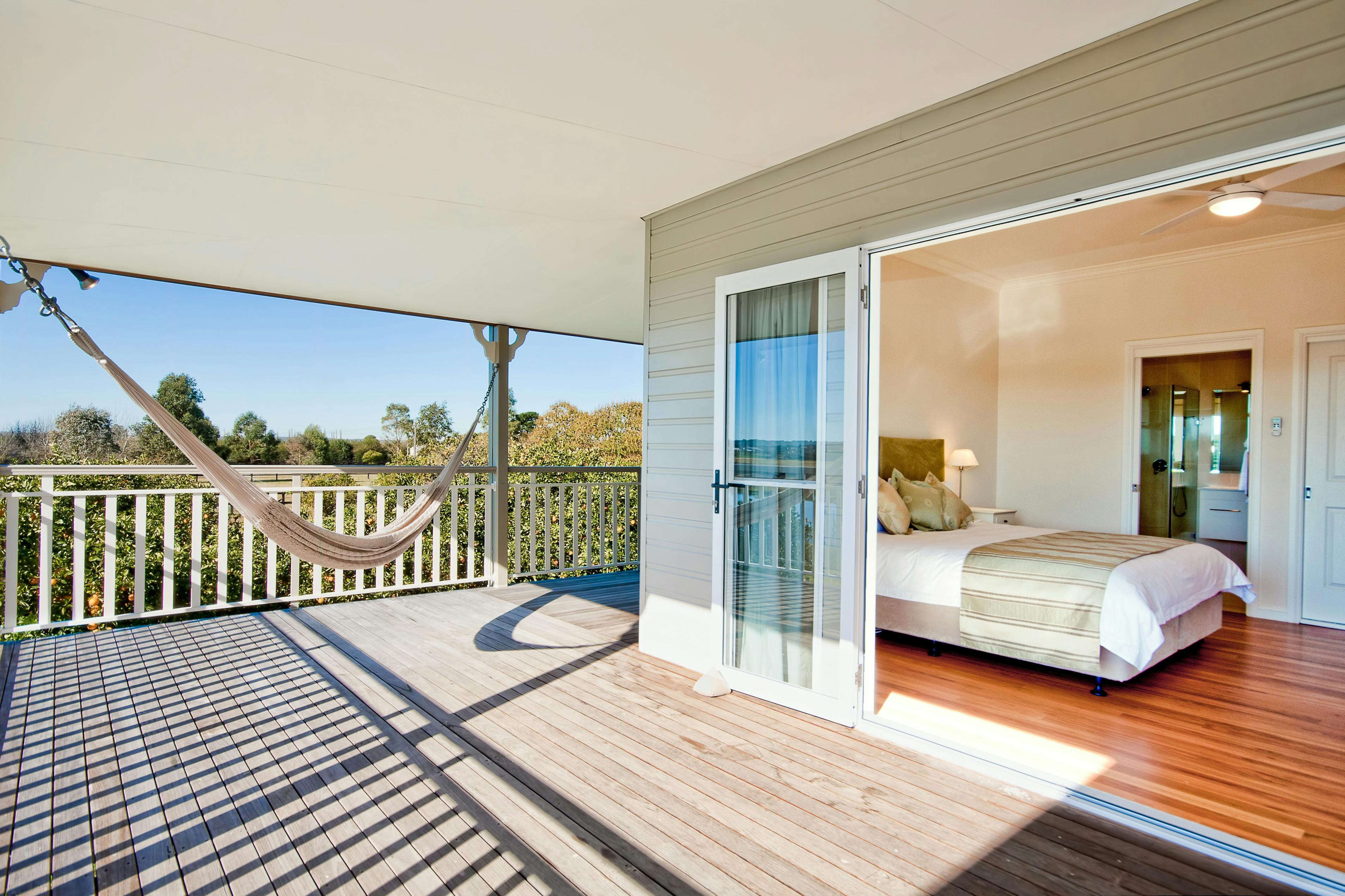Bedroom 2 - sunny north facing river view room with verandah access.
