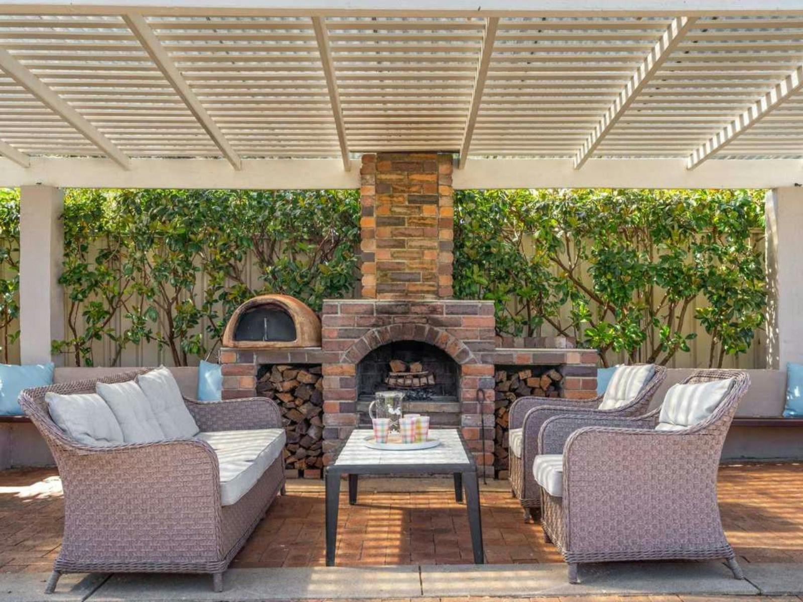 Cosy outdoor lounge with fireplace at Clinton Charm - Stunning Heritage Home near CBD