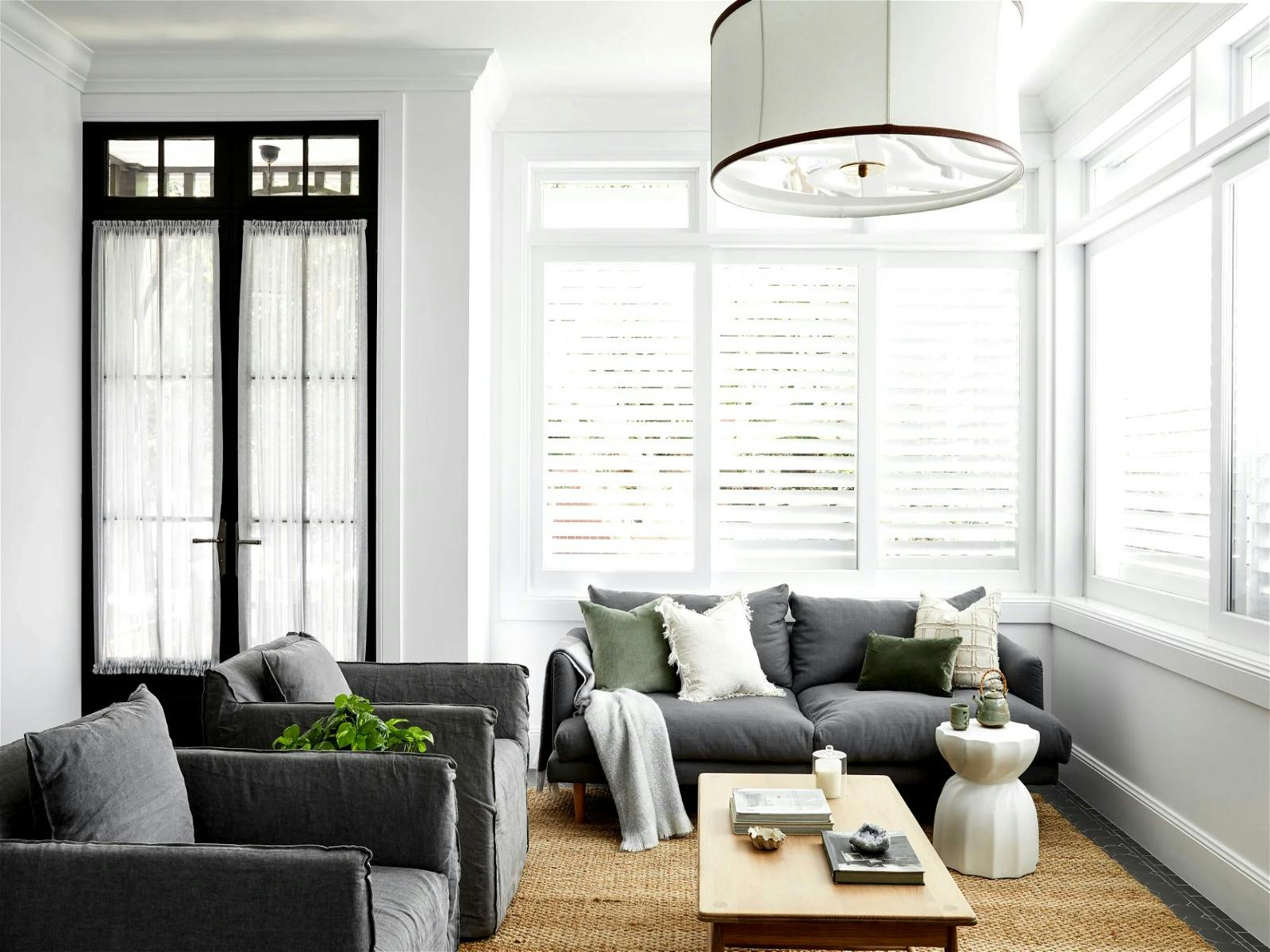 a large kitchen that extends into the dining space and out to the beautiful garden and living room